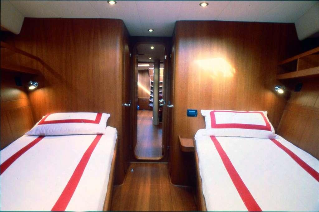 a room with a bed and a mirror aboard CLASS IV Yacht for Charter