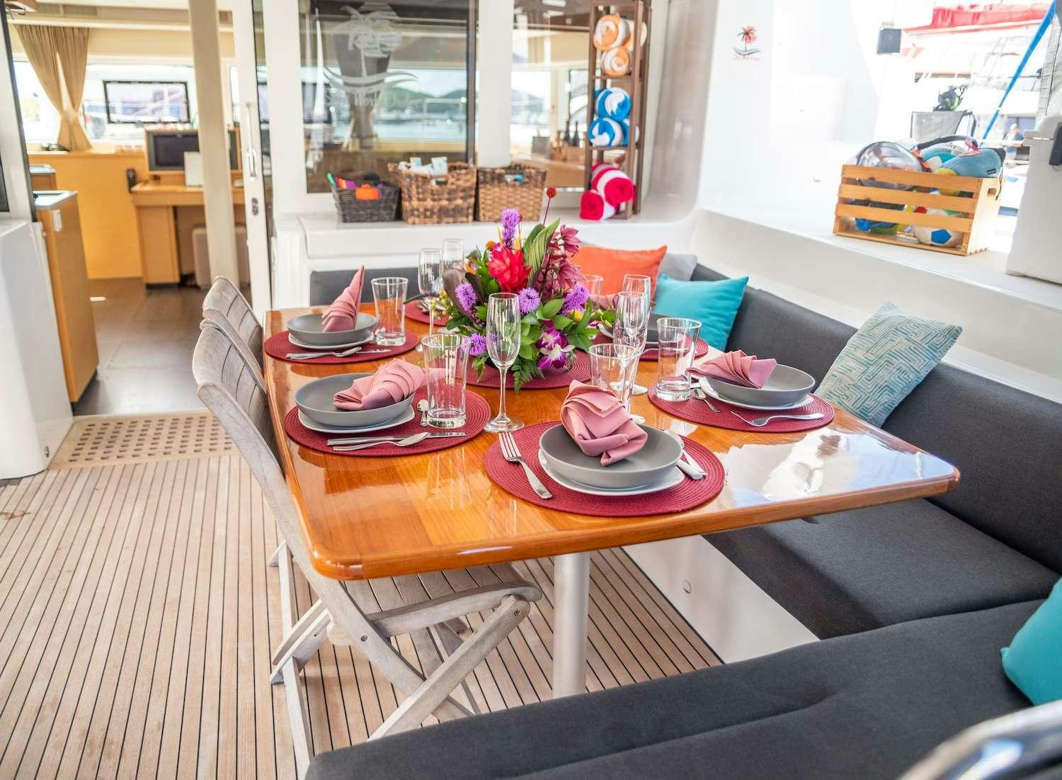 a table with plates and cups on it aboard SOUTHERN COMFORT Yacht for Charter