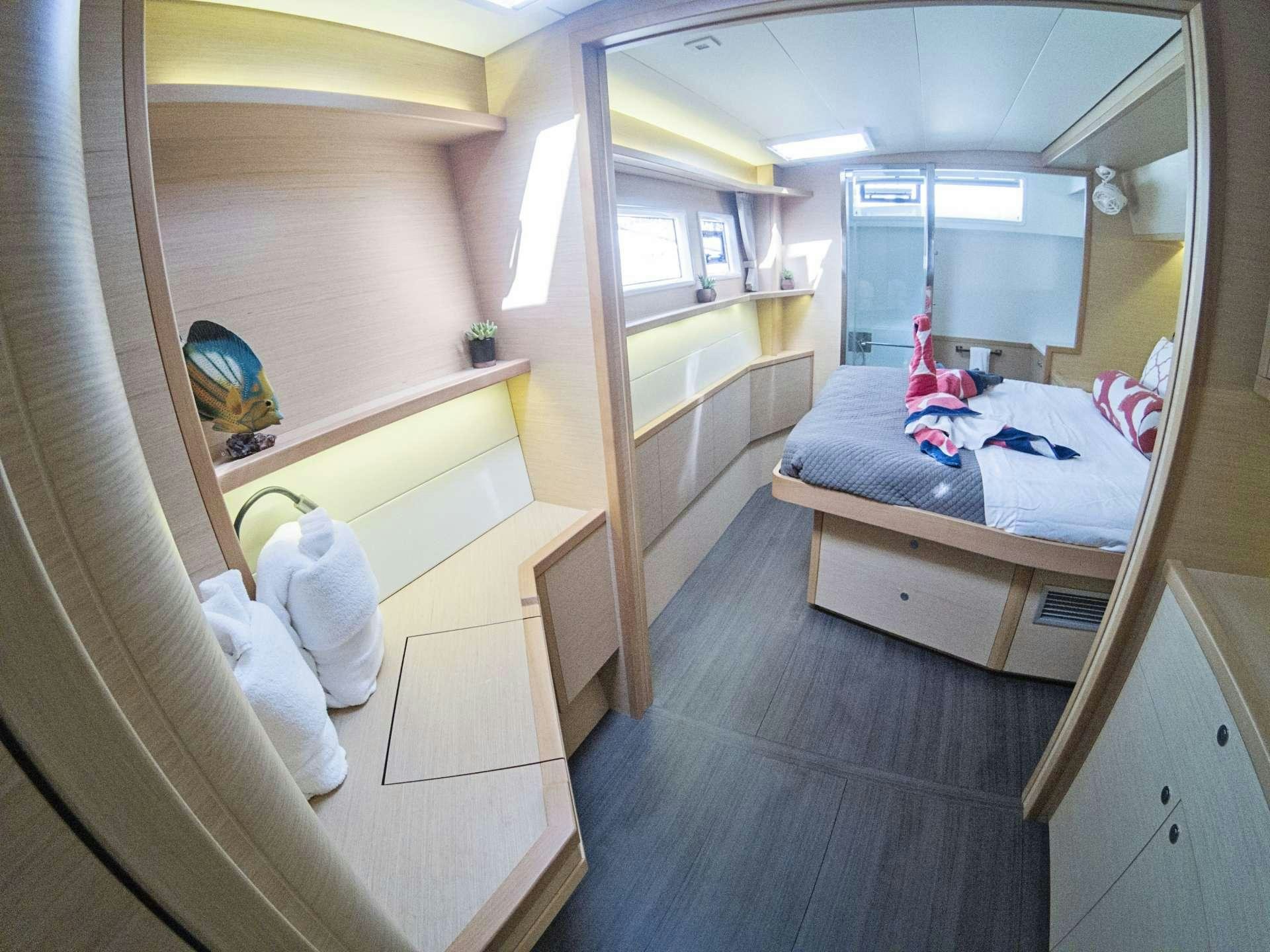 a room with a bed and a mirror aboard SOUTHERN COMFORT Yacht for Charter