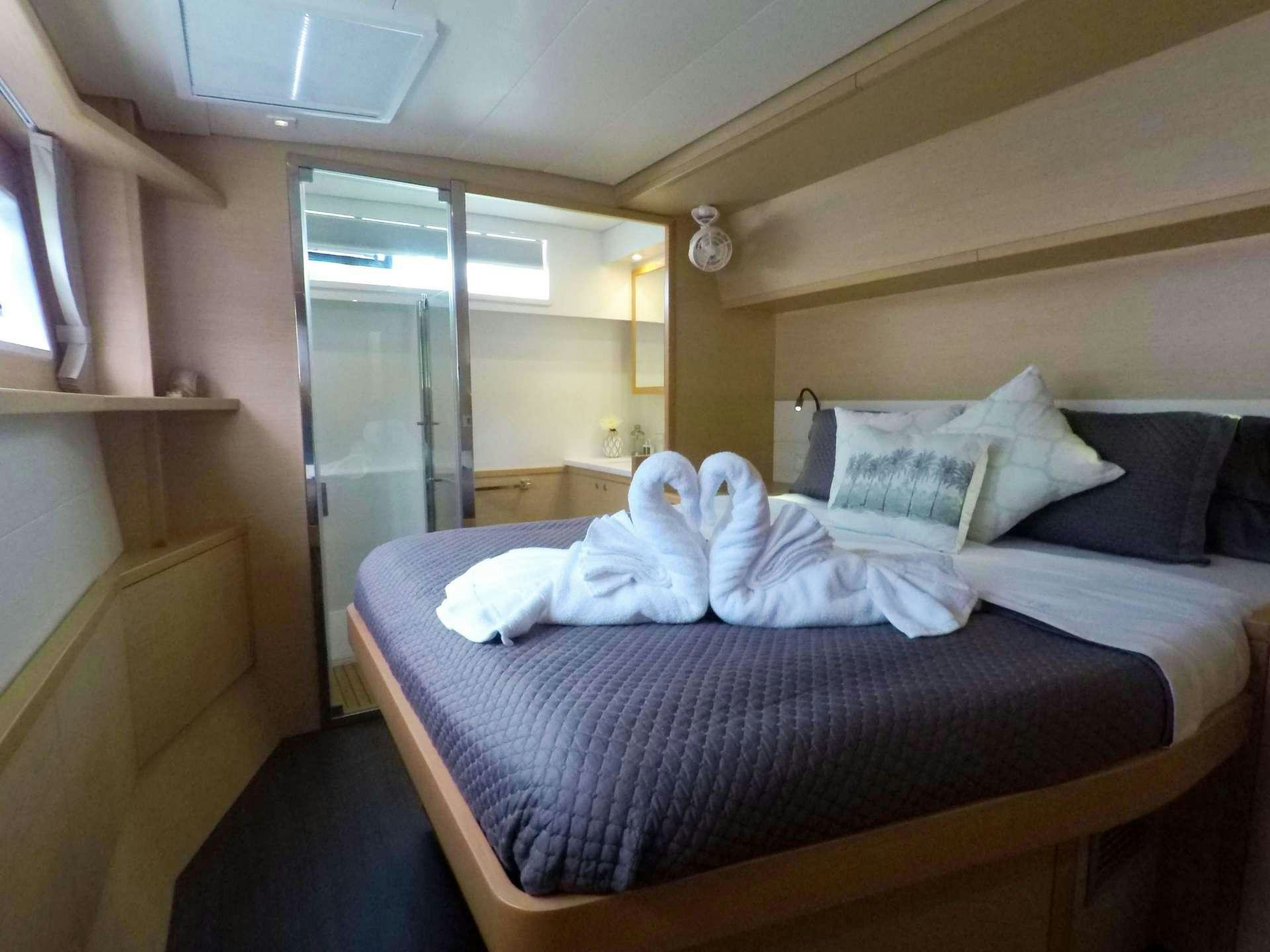 a bed with white sheets aboard SOUTHERN COMFORT Yacht for Charter
