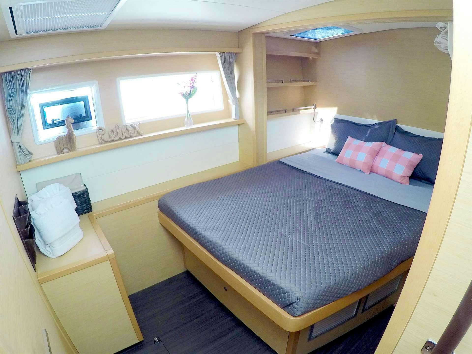 a bed with a blue sheet aboard SOUTHERN COMFORT Yacht for Charter