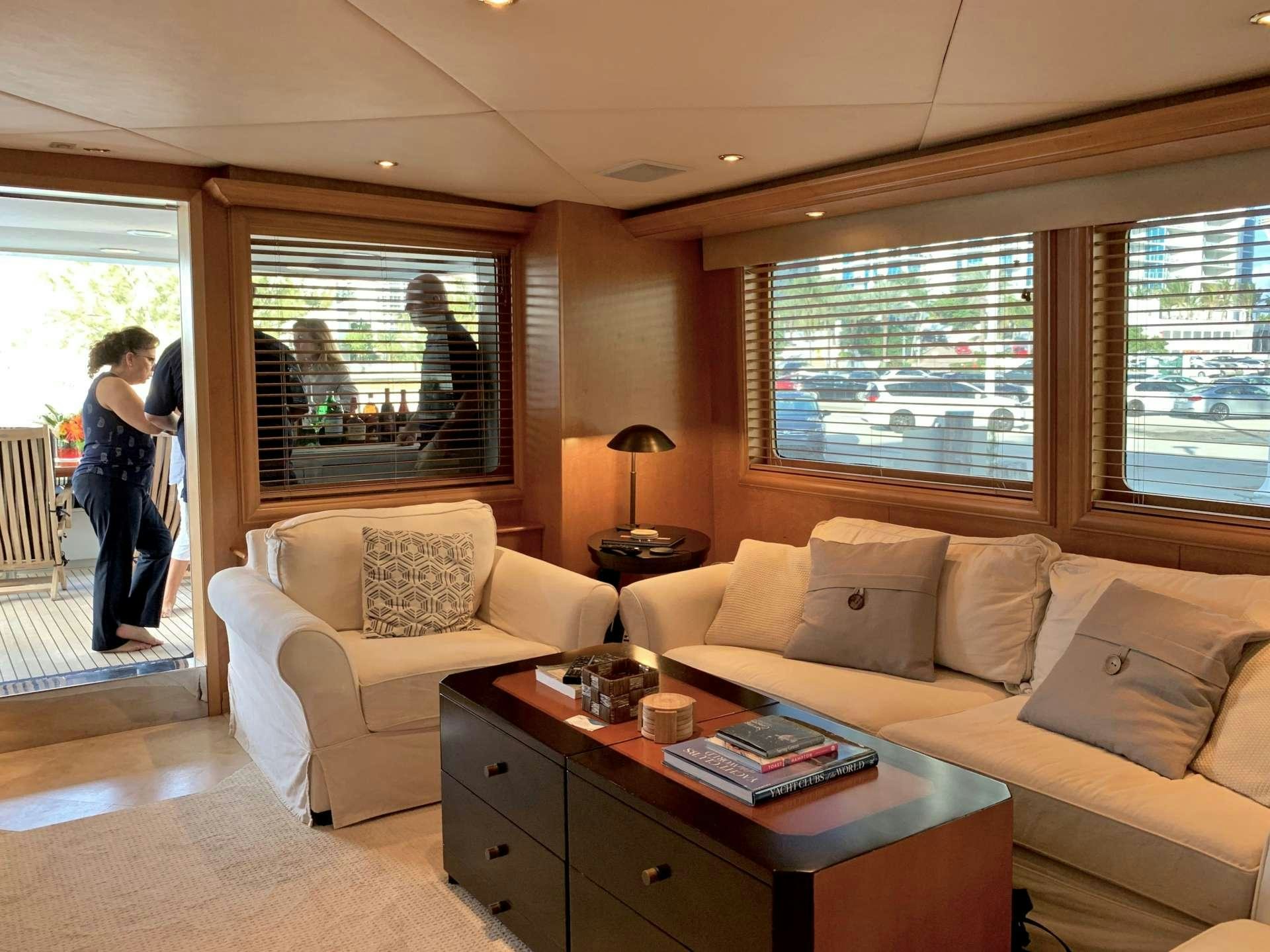 a living room with a couch and a table aboard LADY LEX Yacht for Charter