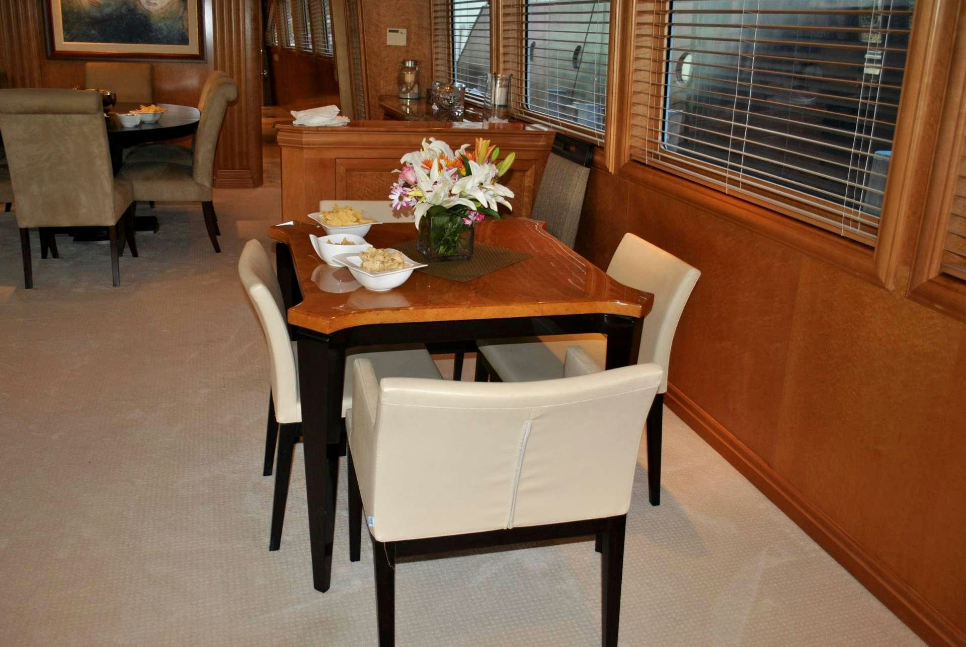 a table with chairs around it aboard LADY LEX Yacht for Charter