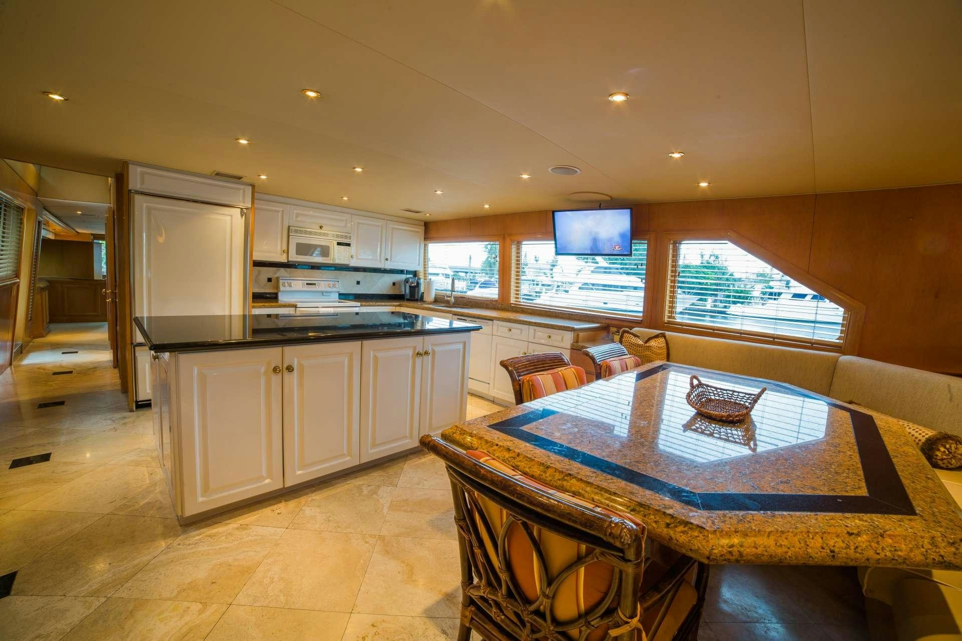 a kitchen with a table and chairs aboard LADY LEX Yacht for Charter
