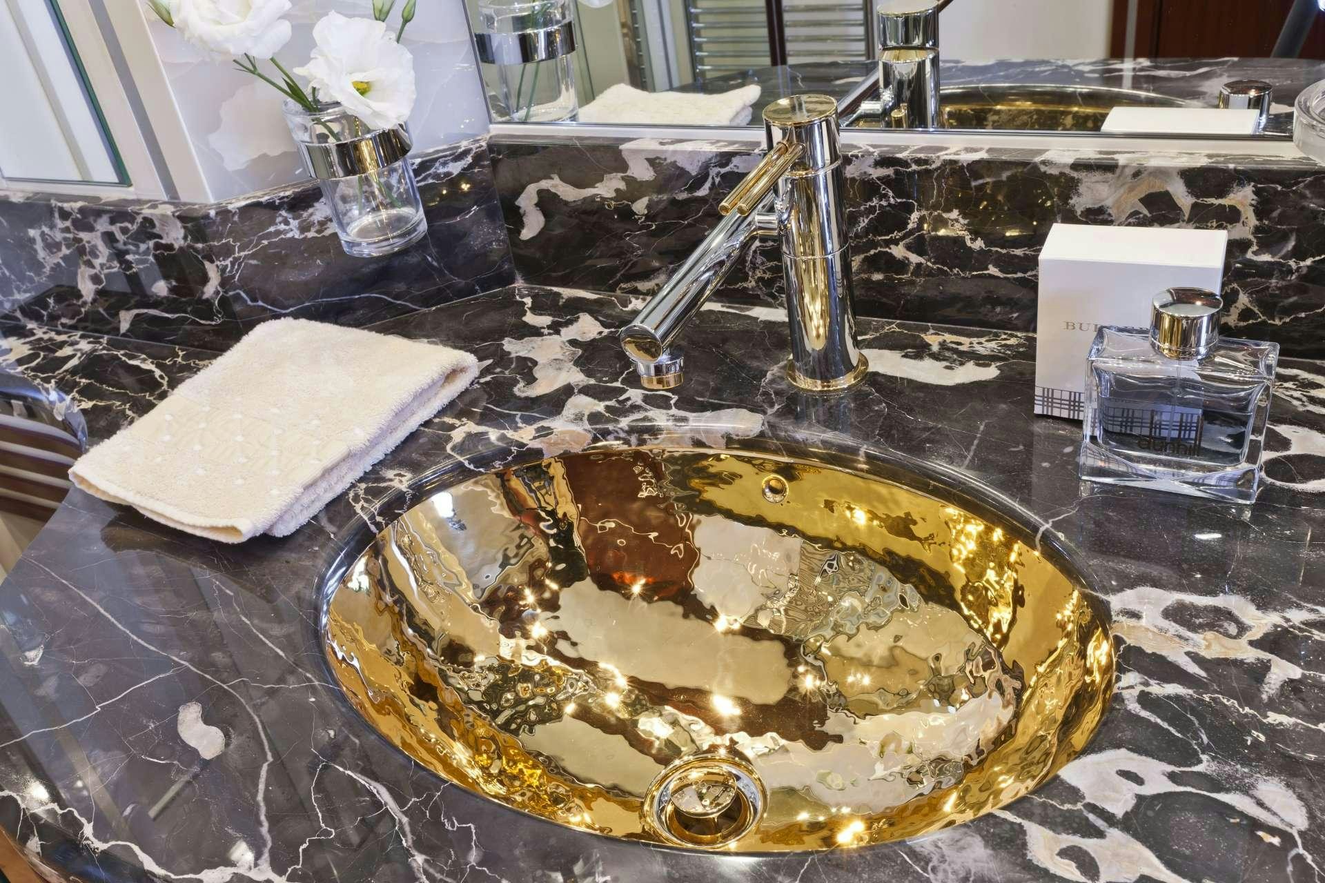 a gold plate with a spoon on it aboard NASEEM Yacht for Charter