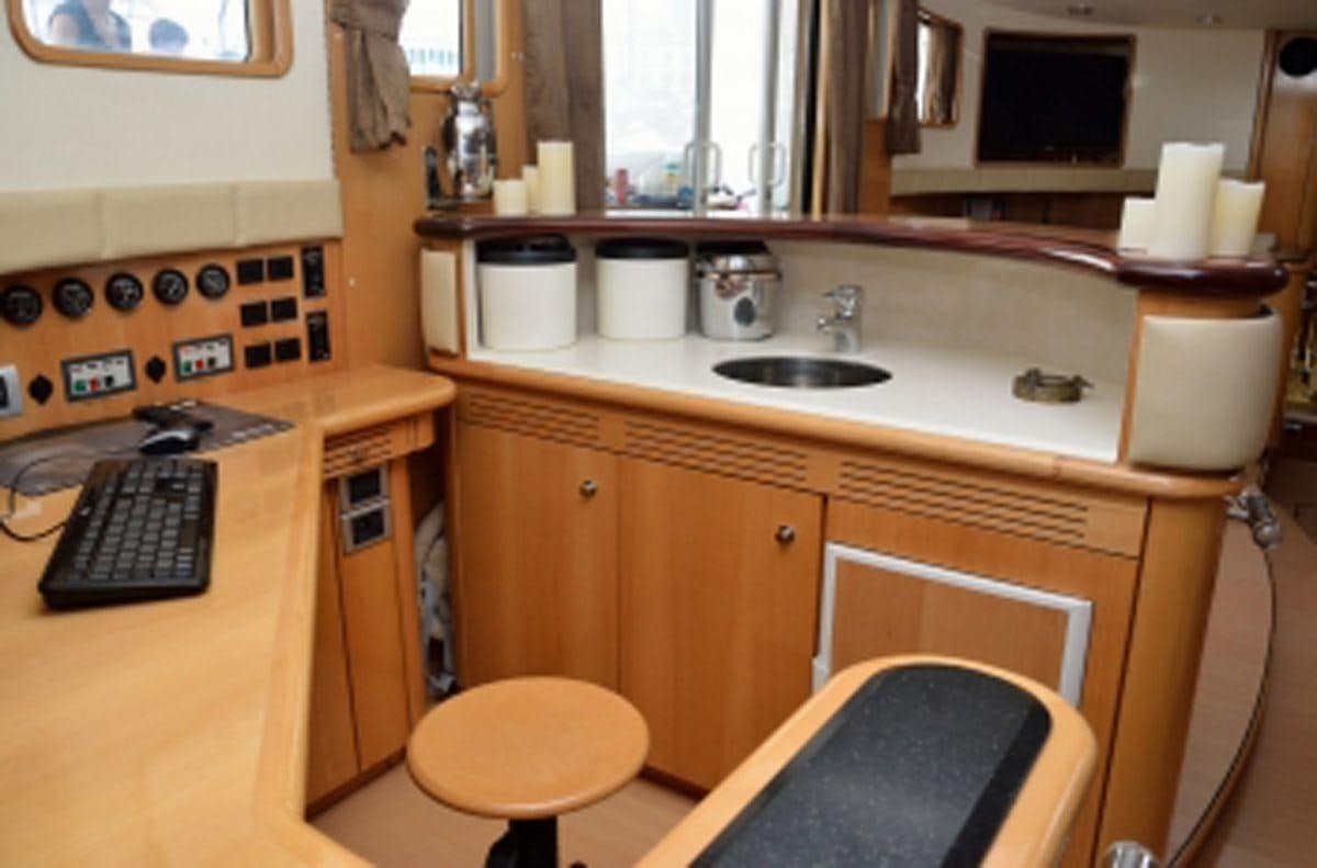a kitchen with a sink and a computer aboard SAGITTARIUS Yacht for Charter