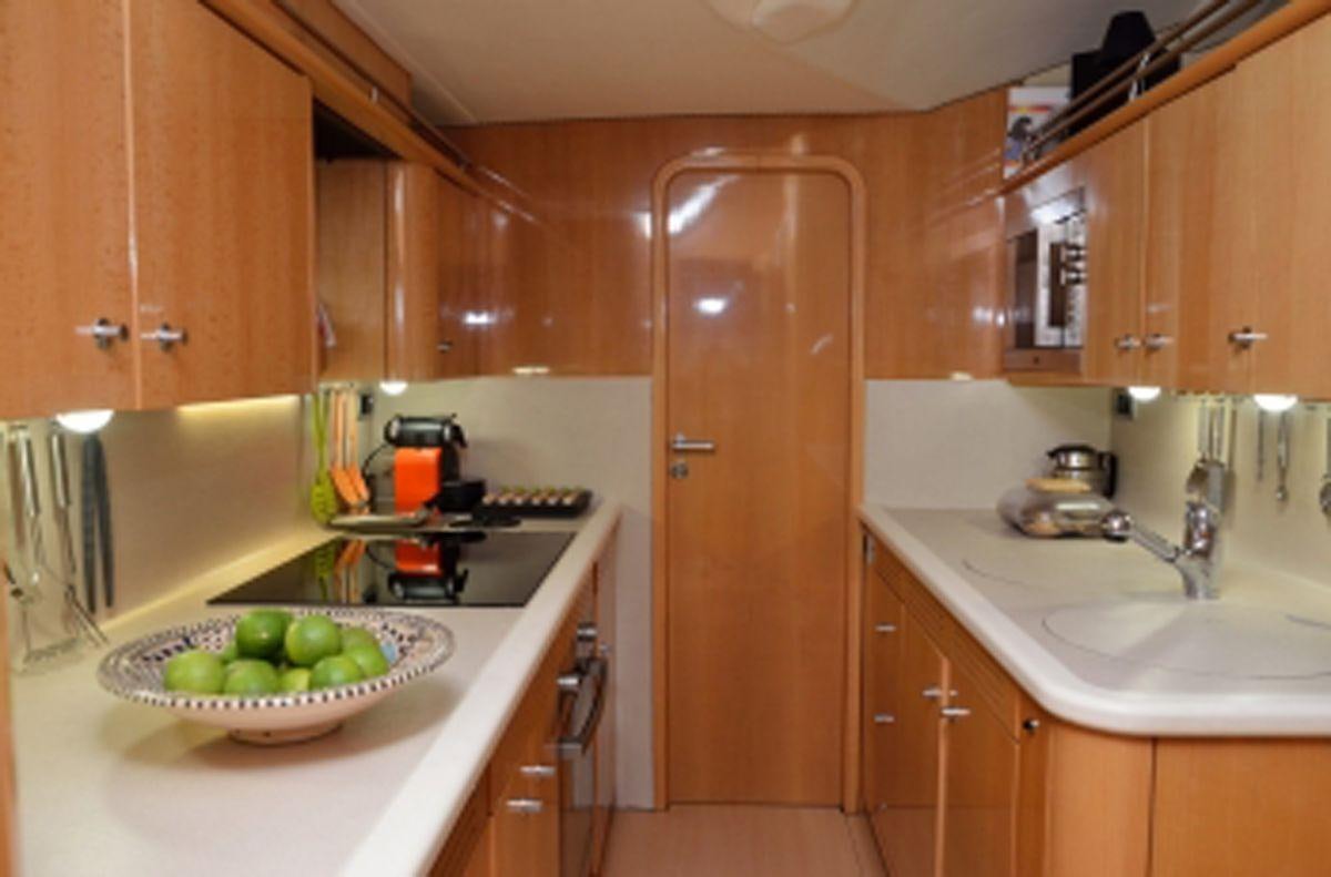 a kitchen with wooden cabinets aboard SAGITTARIUS Yacht for Charter