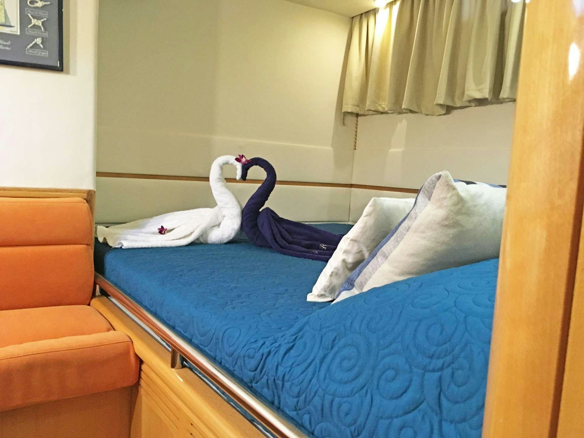 a white horse lying on a bed aboard SAGITTARIUS Yacht for Charter