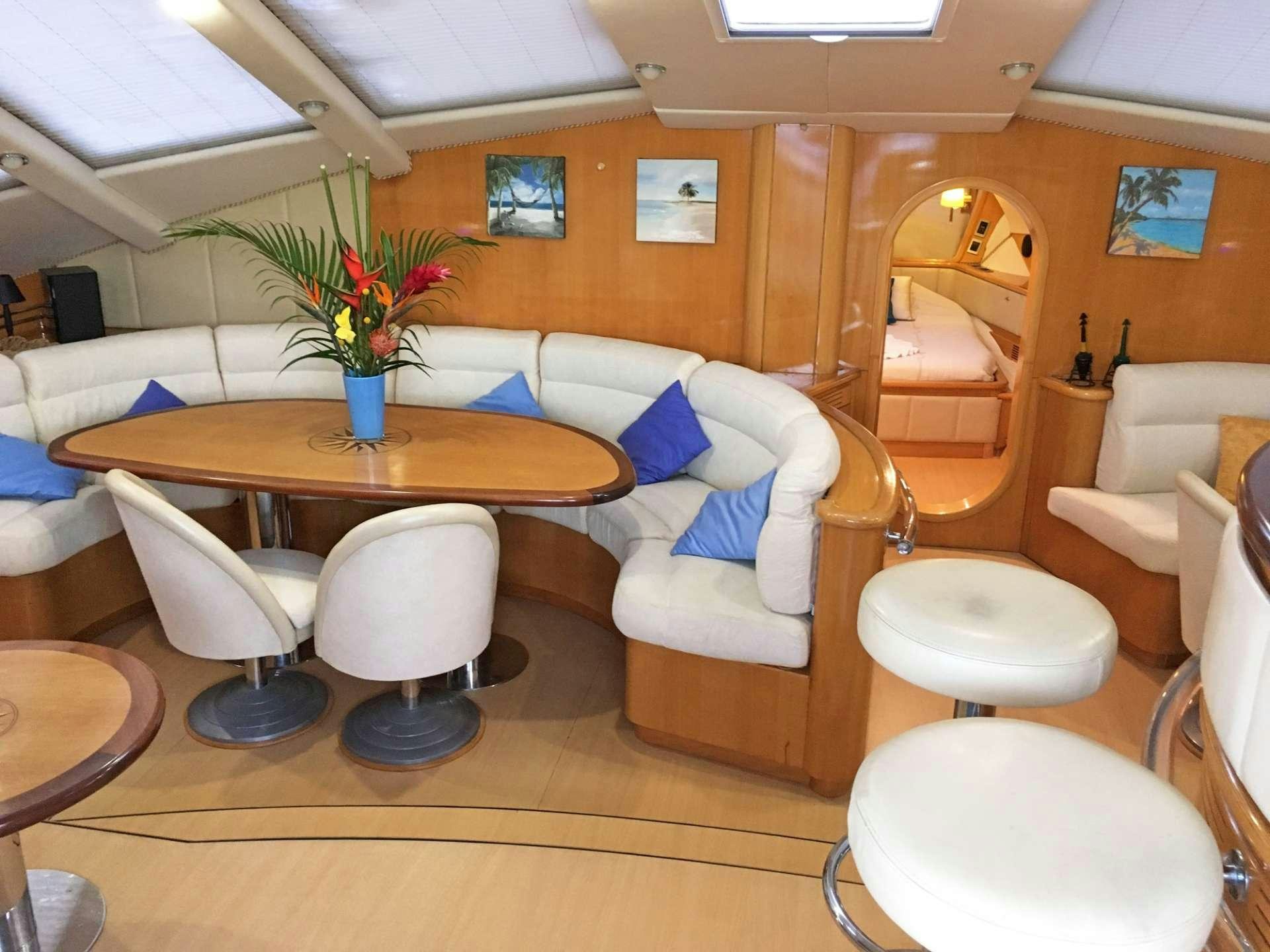 a room with a table and chairs aboard SAGITTARIUS Yacht for Charter