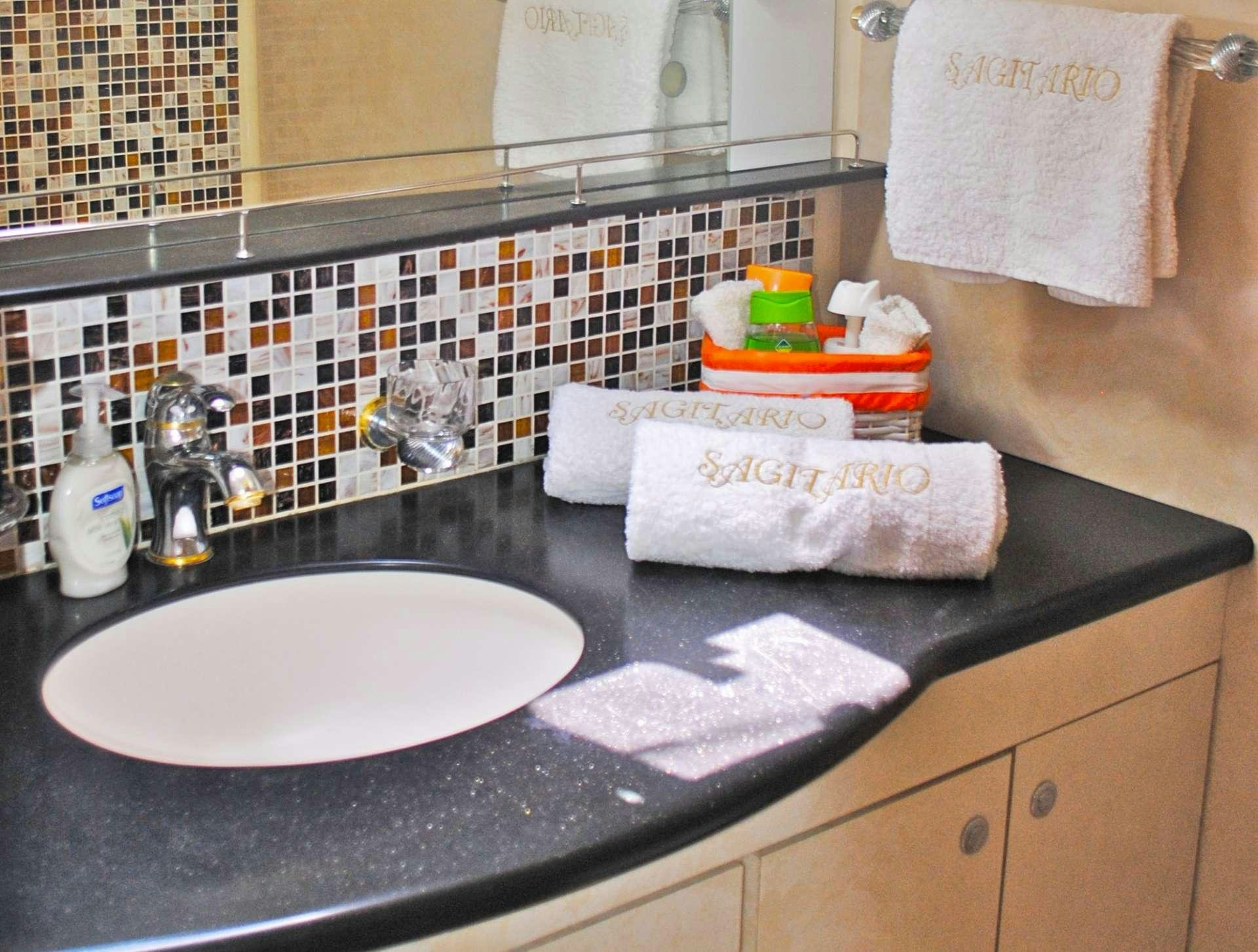 a bathroom counter with a sink and towels aboard SAGITTARIUS Yacht for Charter