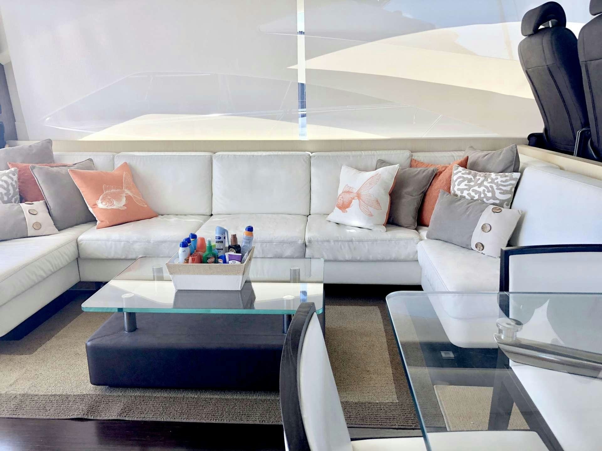 a living room with a couch and a table aboard DOLCE VITA Yacht for Charter