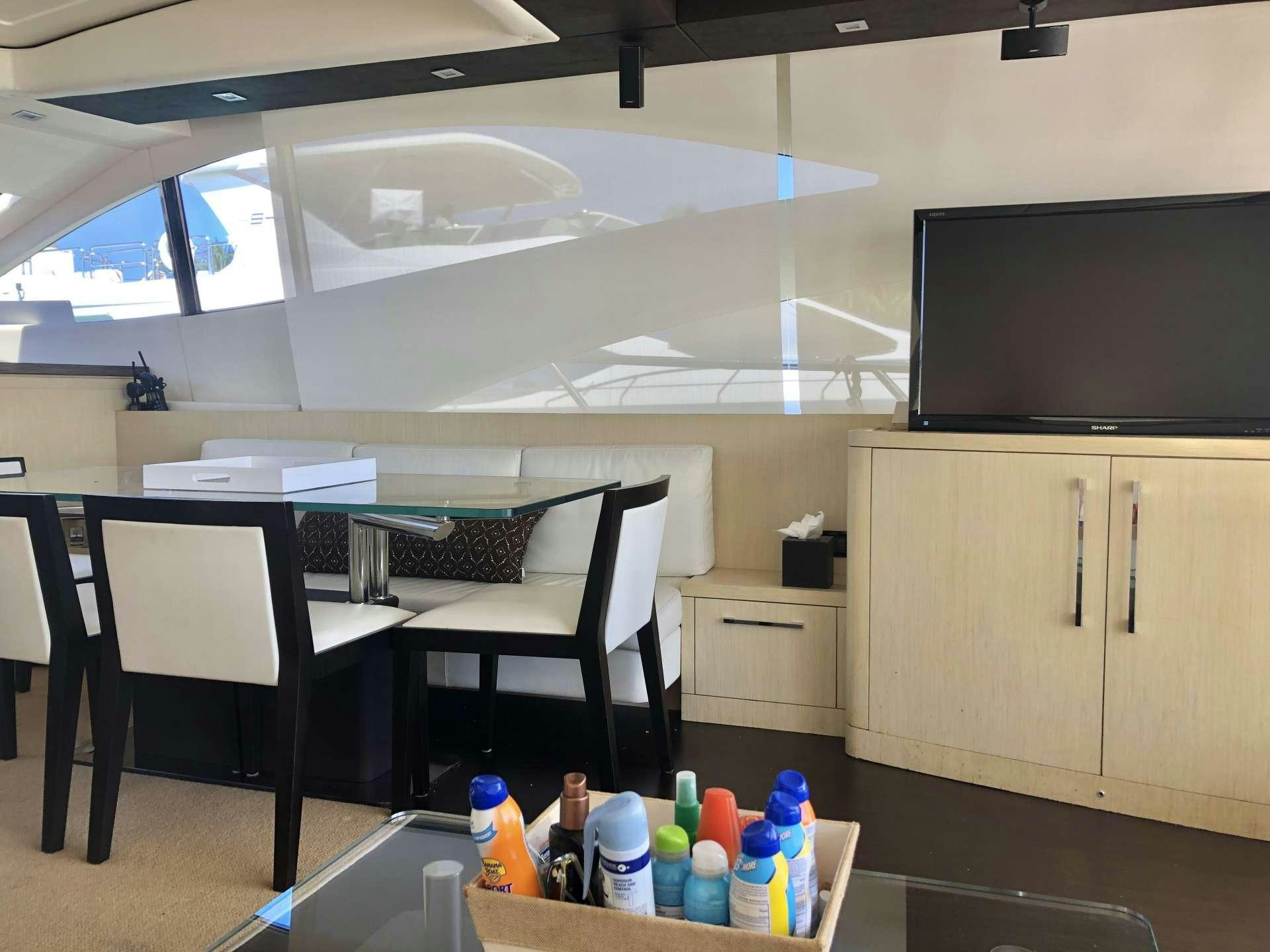 a room with a table and chairs aboard DOLCE VITA Yacht for Charter