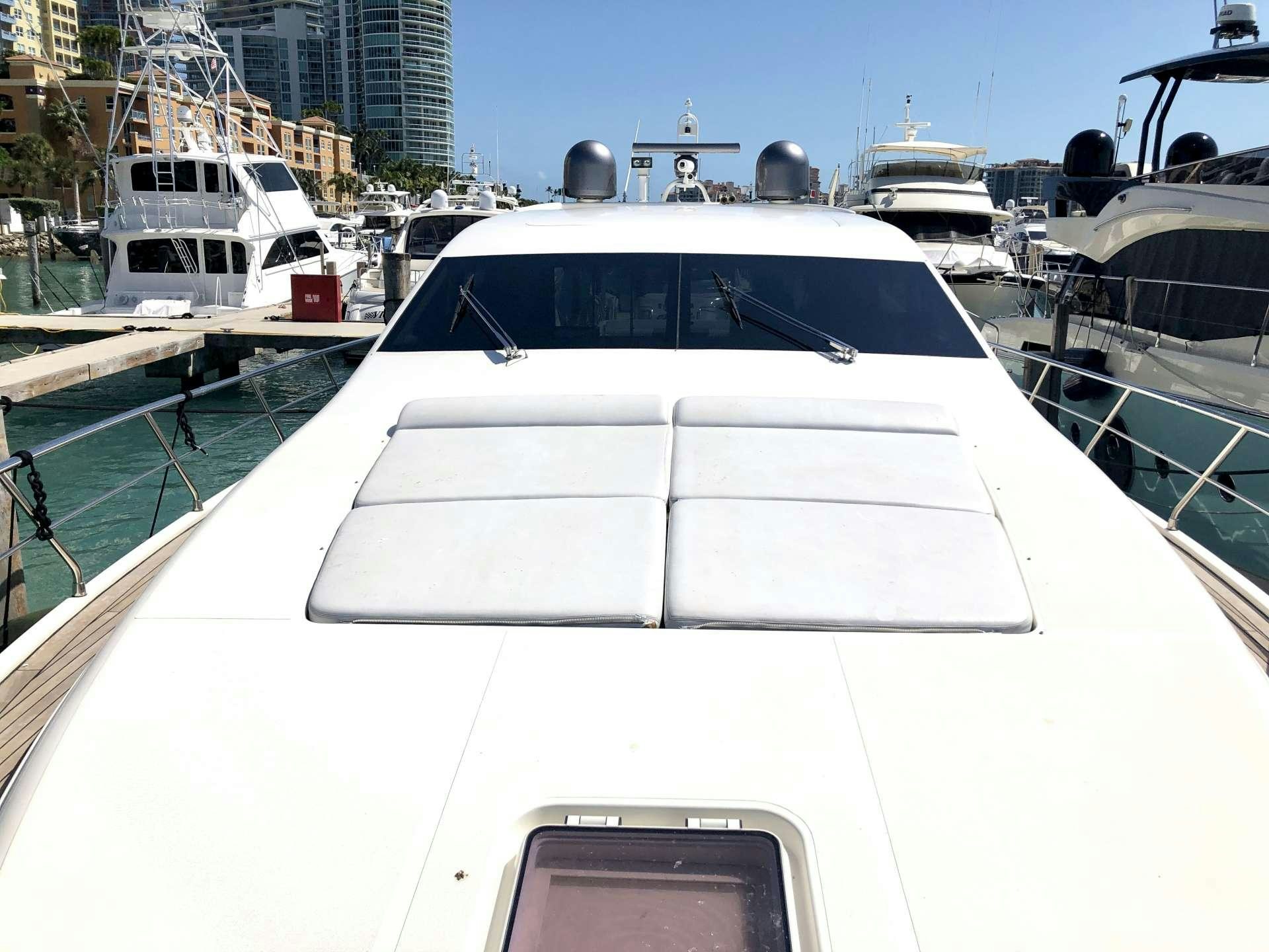 a white yacht in a harbor aboard DOLCE VITA Yacht for Charter