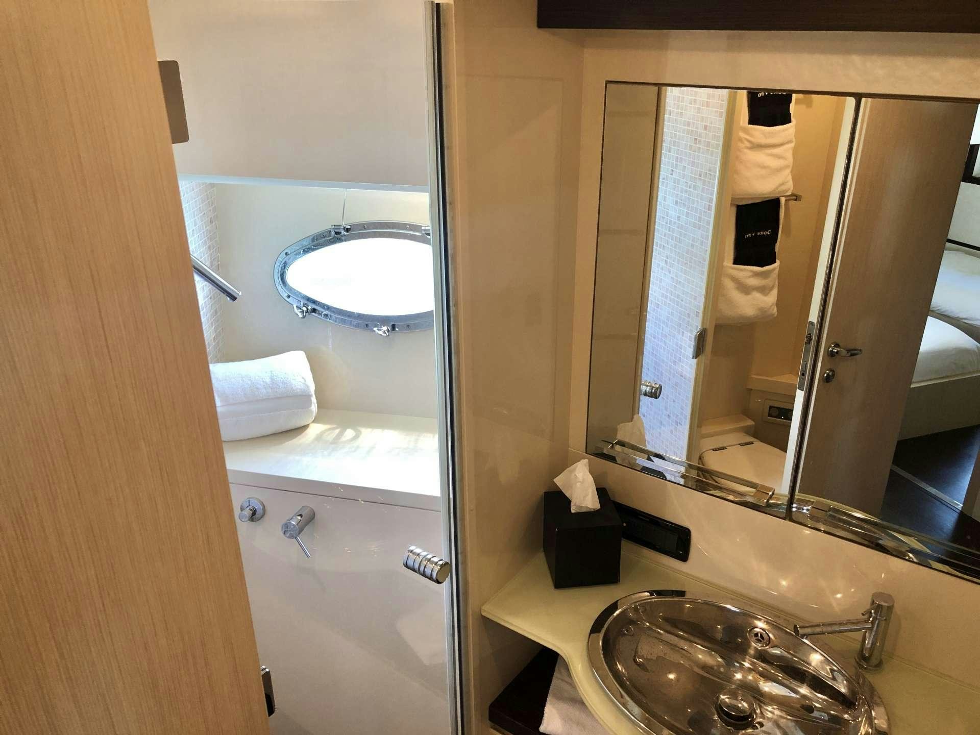 a bathroom with a large mirror aboard DOLCE VITA Yacht for Charter