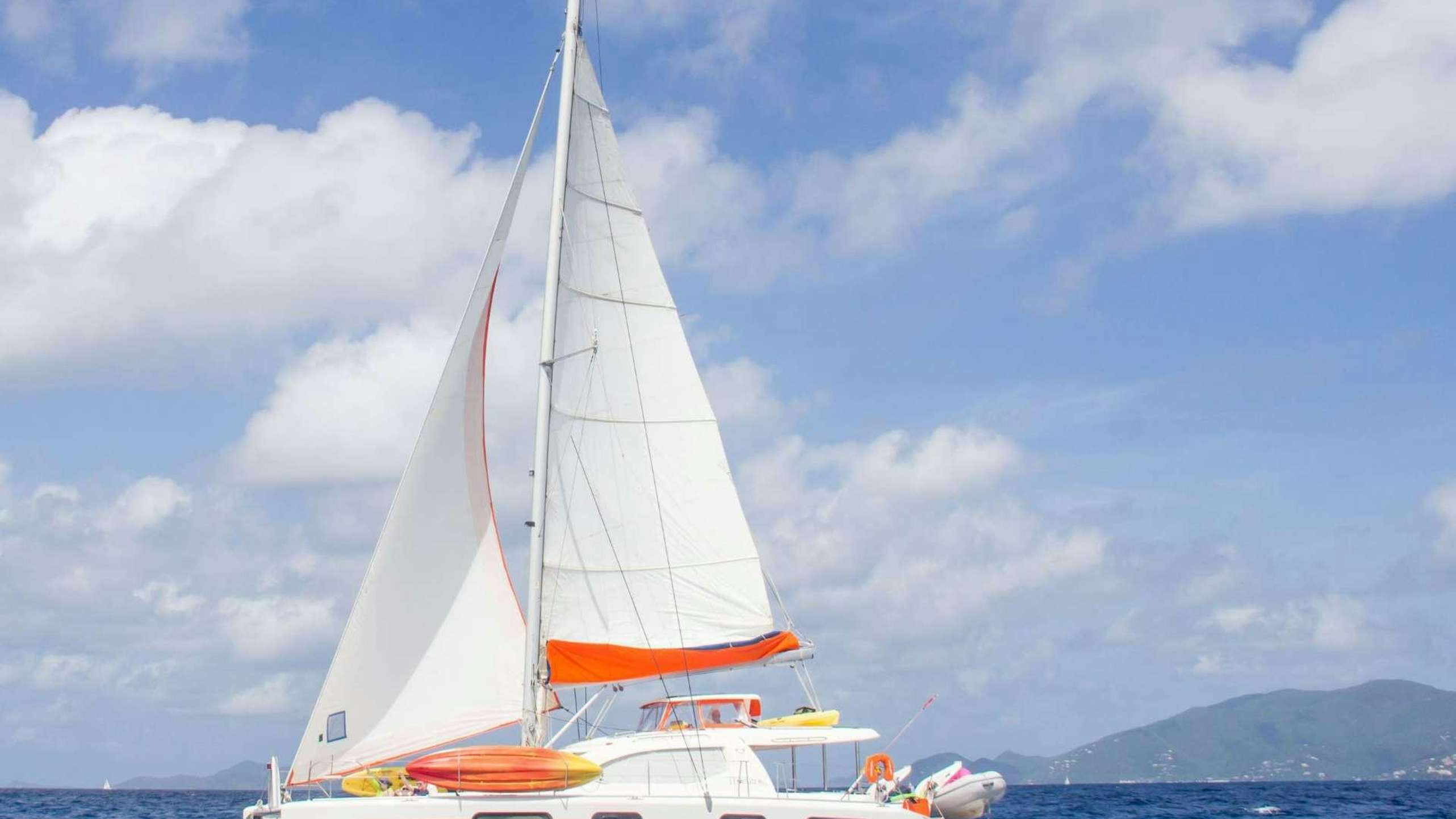 a white sailboat on the water aboard STARFISH Yacht for Charter