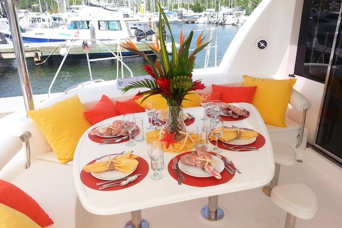 a table with plates and food on it aboard STARFISH Yacht for Charter