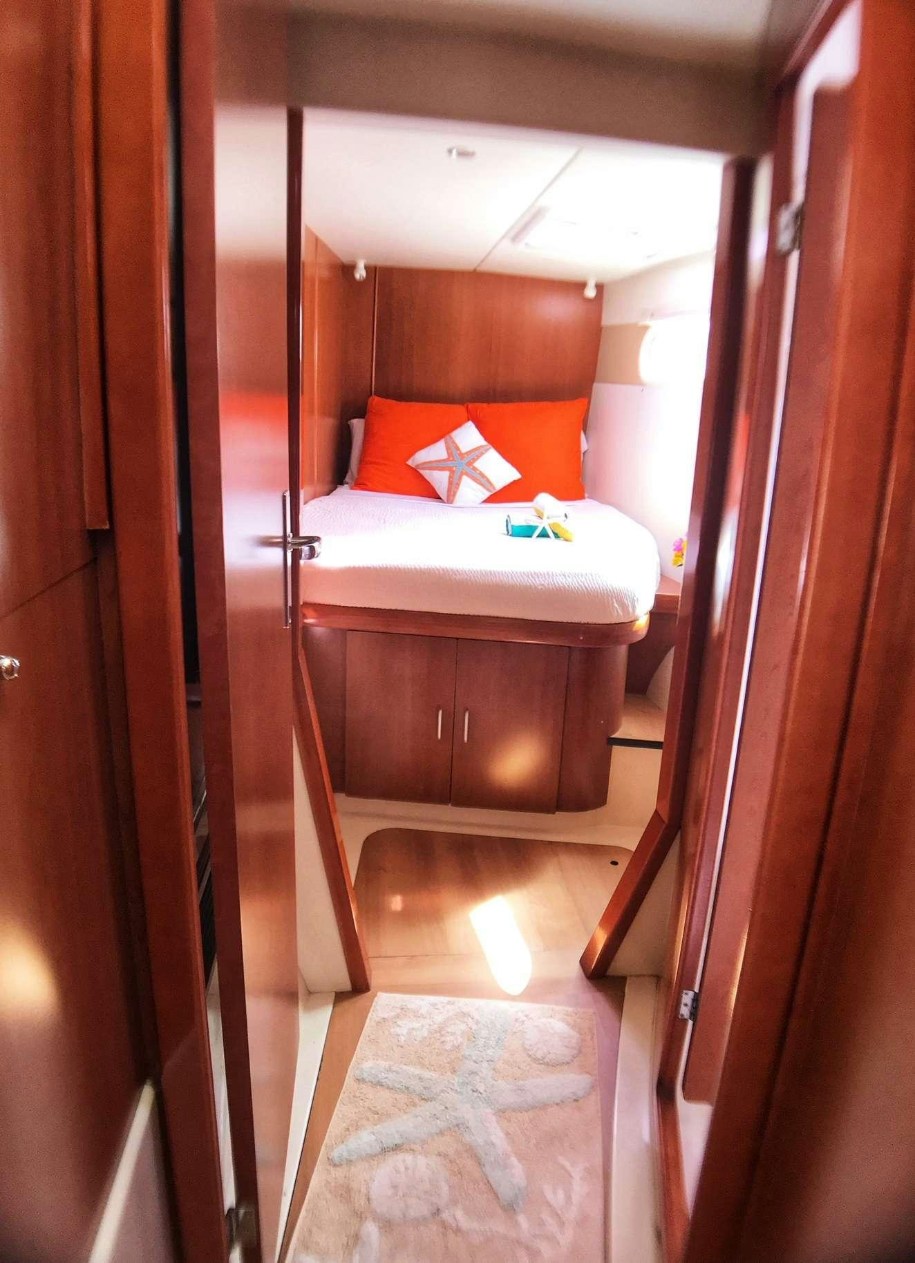 a small bedroom with a bed aboard STARFISH Yacht for Charter