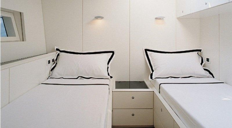 a couple of beds in a room aboard DARK SHADOW Yacht for Charter
