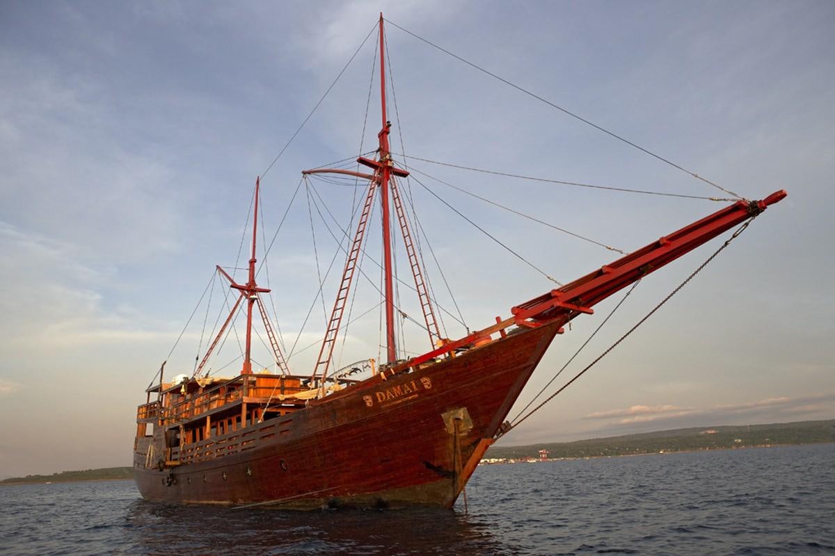 a red boat in the water aboard DAMAI Yacht for Charter