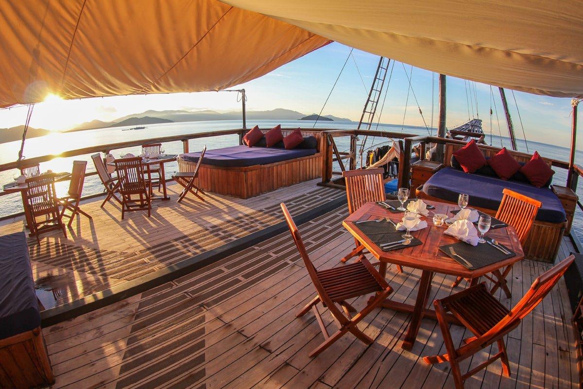 a tent with a table and chairs aboard DAMAI Yacht for Charter