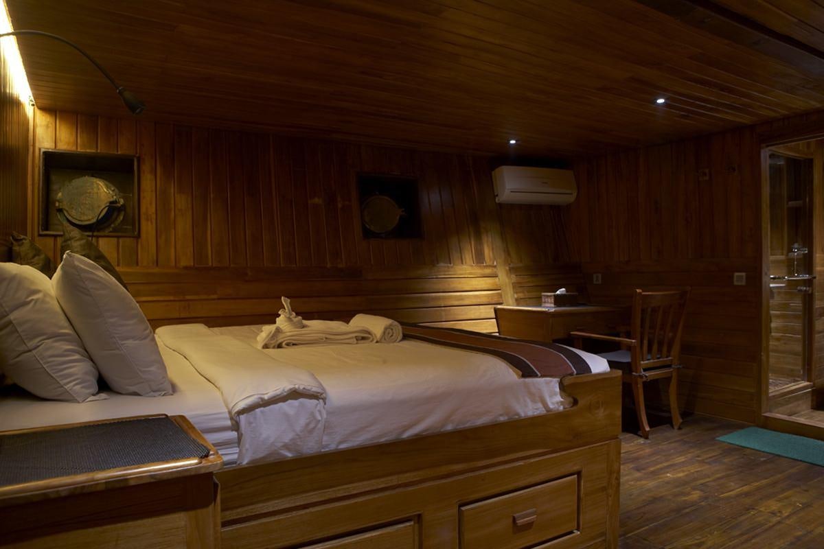 a bed in a cabin aboard DAMAI Yacht for Charter