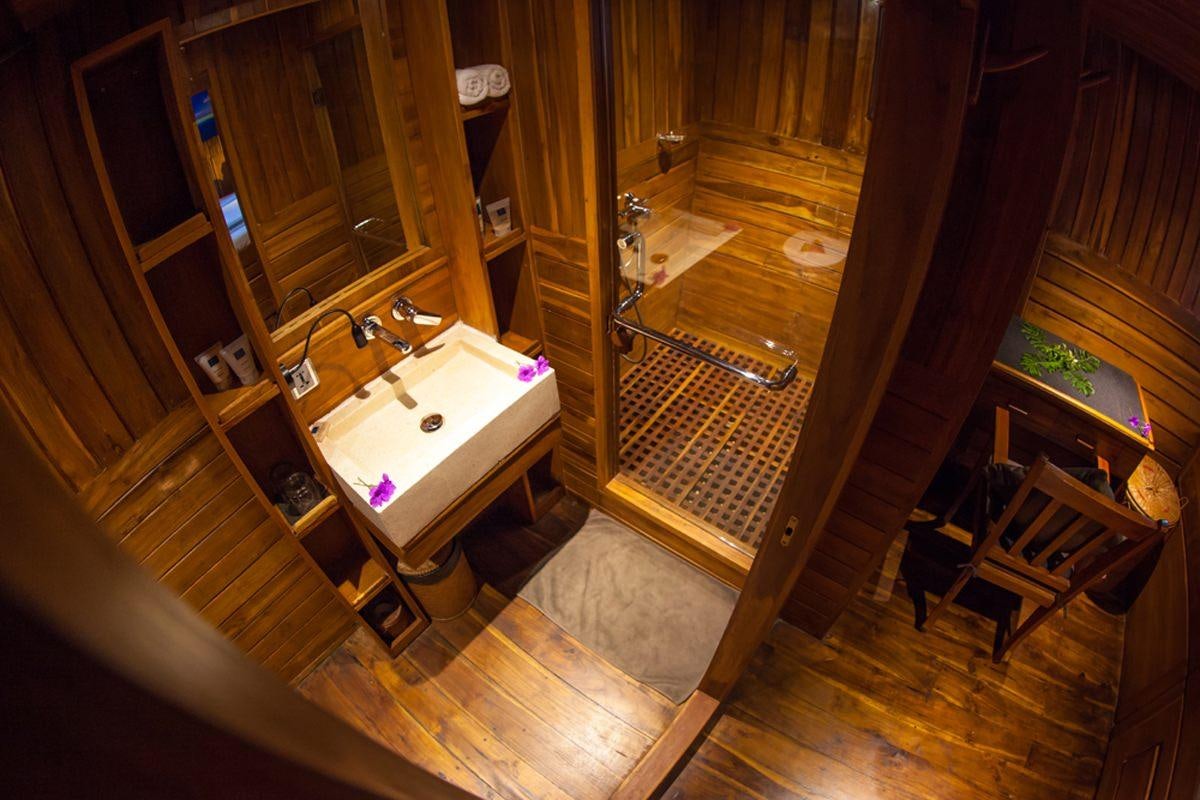 a bathroom with a sink and a mirror aboard DAMAI Yacht for Charter