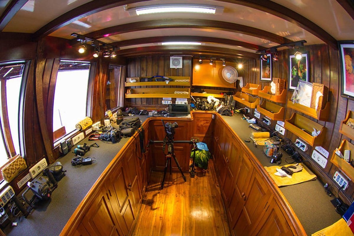 a room with a desk and a computer aboard DAMAI Yacht for Charter