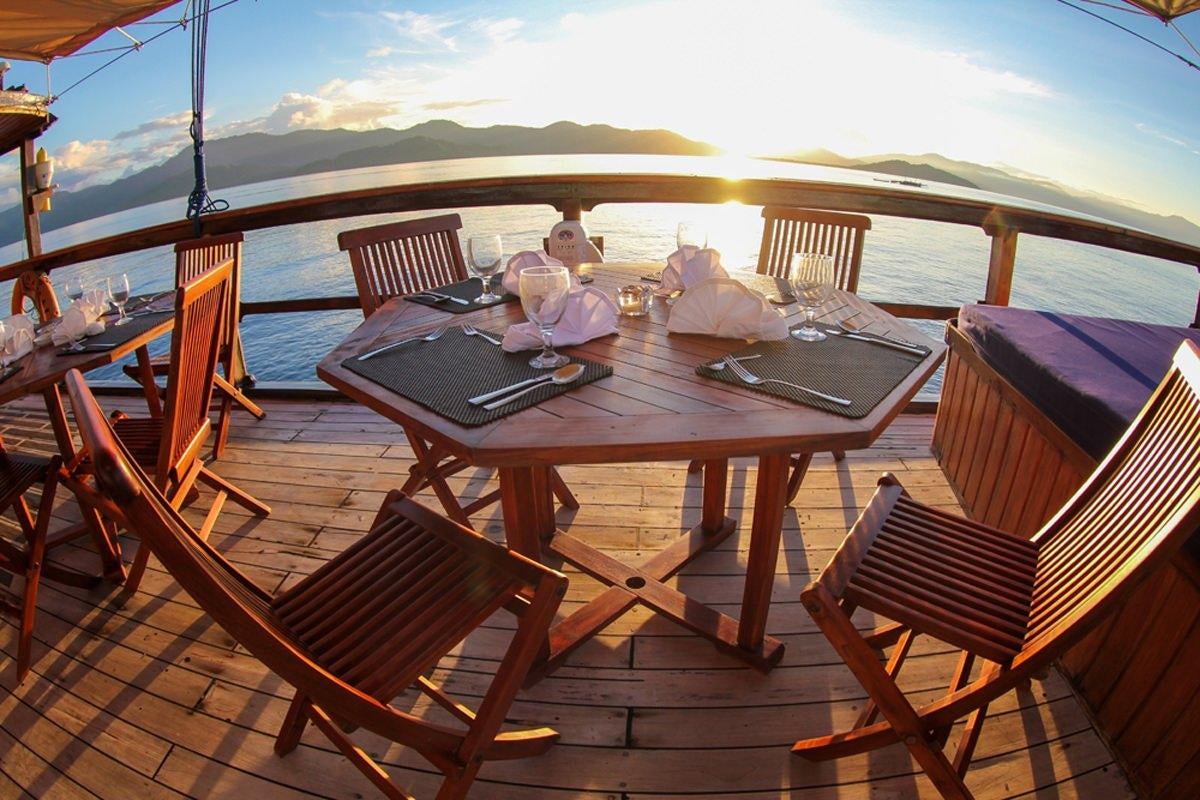 a table on a deck aboard DAMAI Yacht for Charter