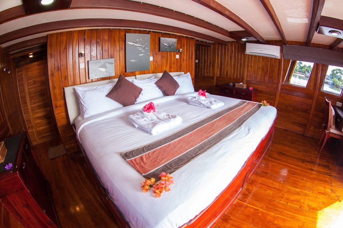 a bed in a cabin aboard DAMAI Yacht for Charter