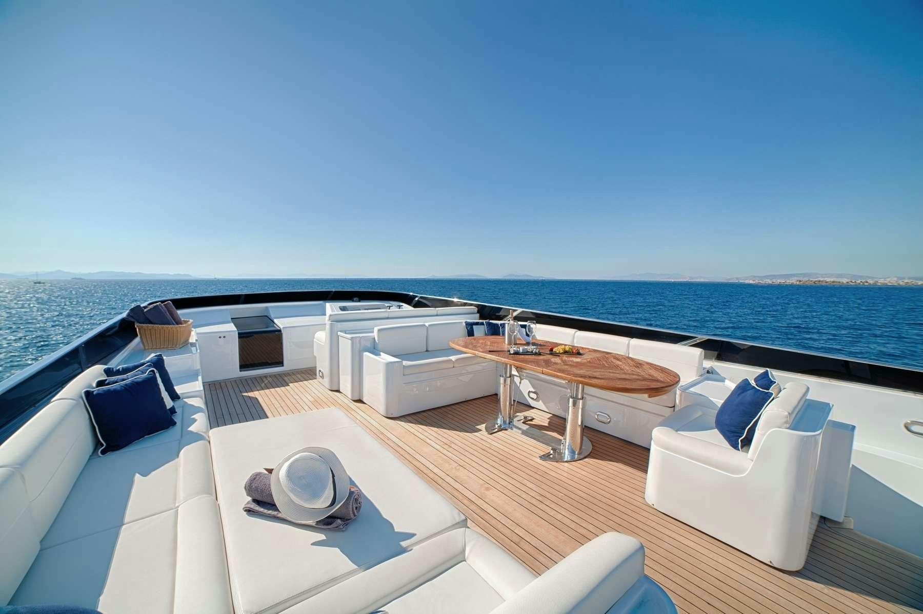 a large white lounge chair on a deck overlooking a large body of water aboard ZOI Yacht for Charter