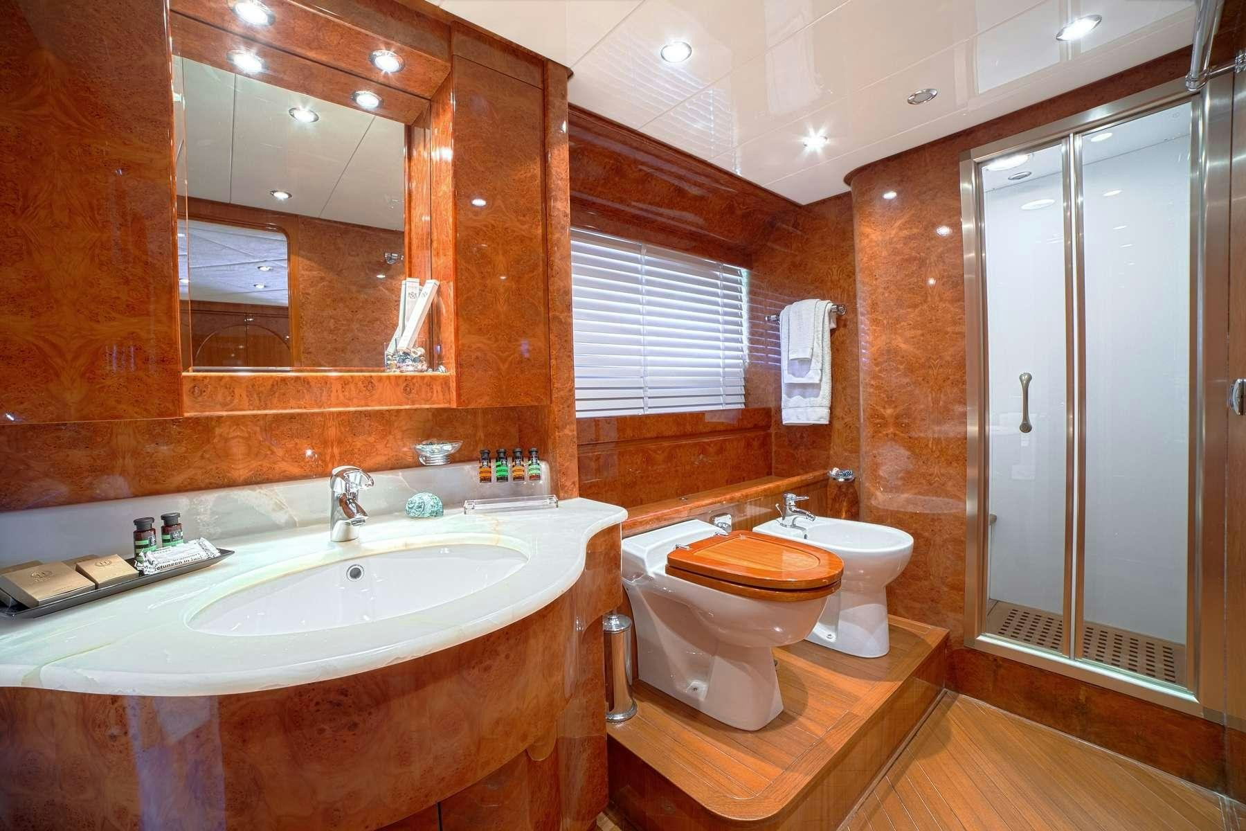 a bathroom with a sink toilet and a mirror aboard ZOI Yacht for Charter