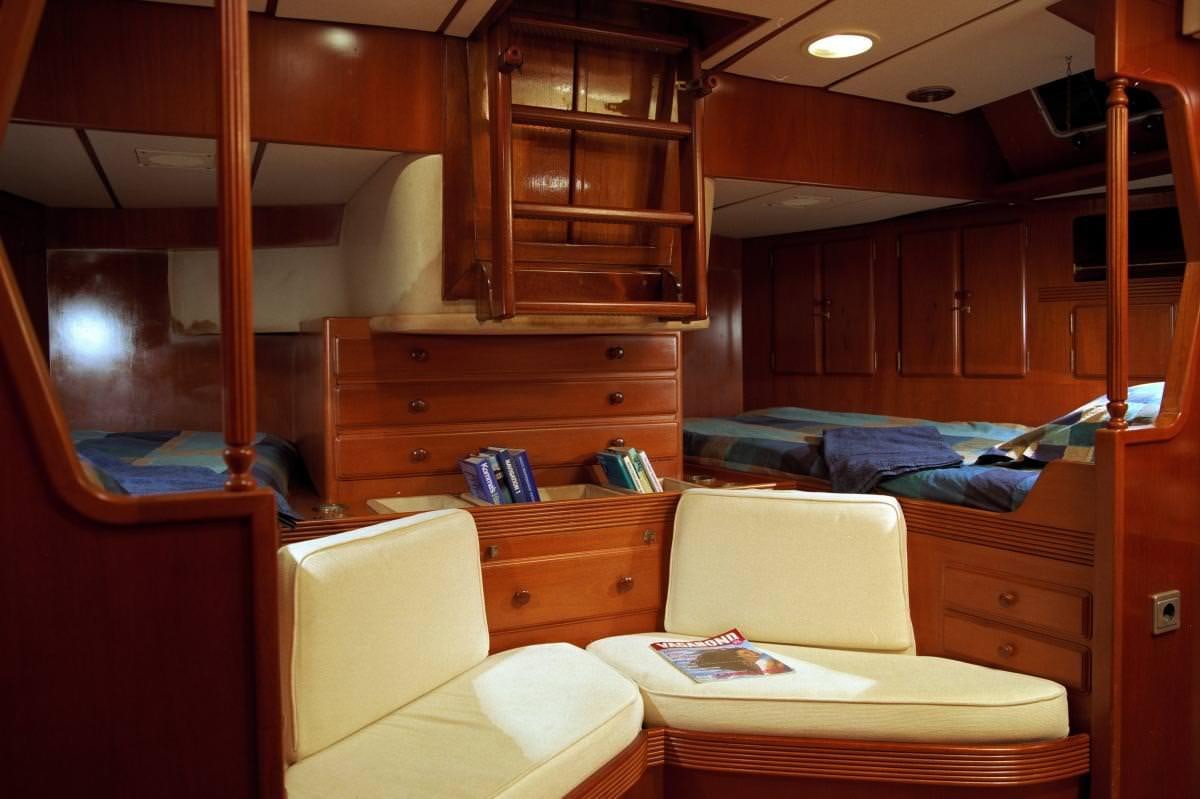 a room with a bed and a desk aboard ICHIBAN Yacht for Charter