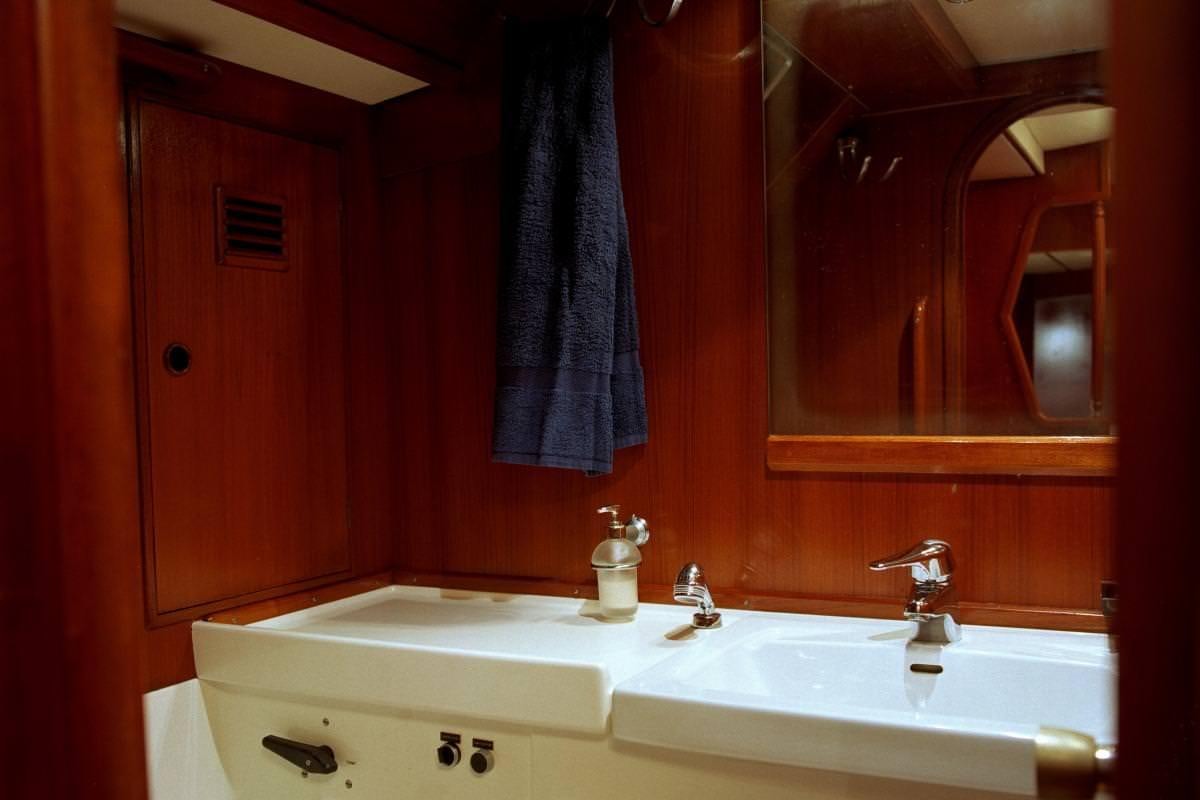 a bathroom with red walls aboard ICHIBAN Yacht for Charter