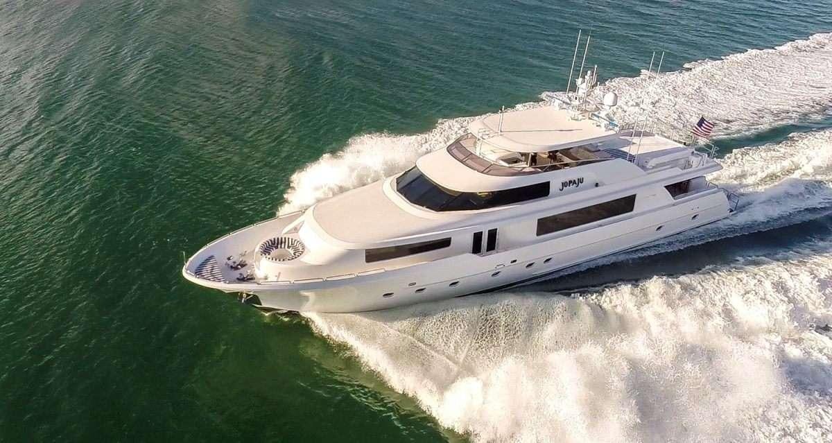 a white boat in the water aboard NAUTI N' Yacht for Charter