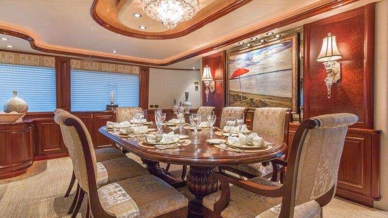a dining room with a table and chairs aboard NAUTI N' Yacht for Charter