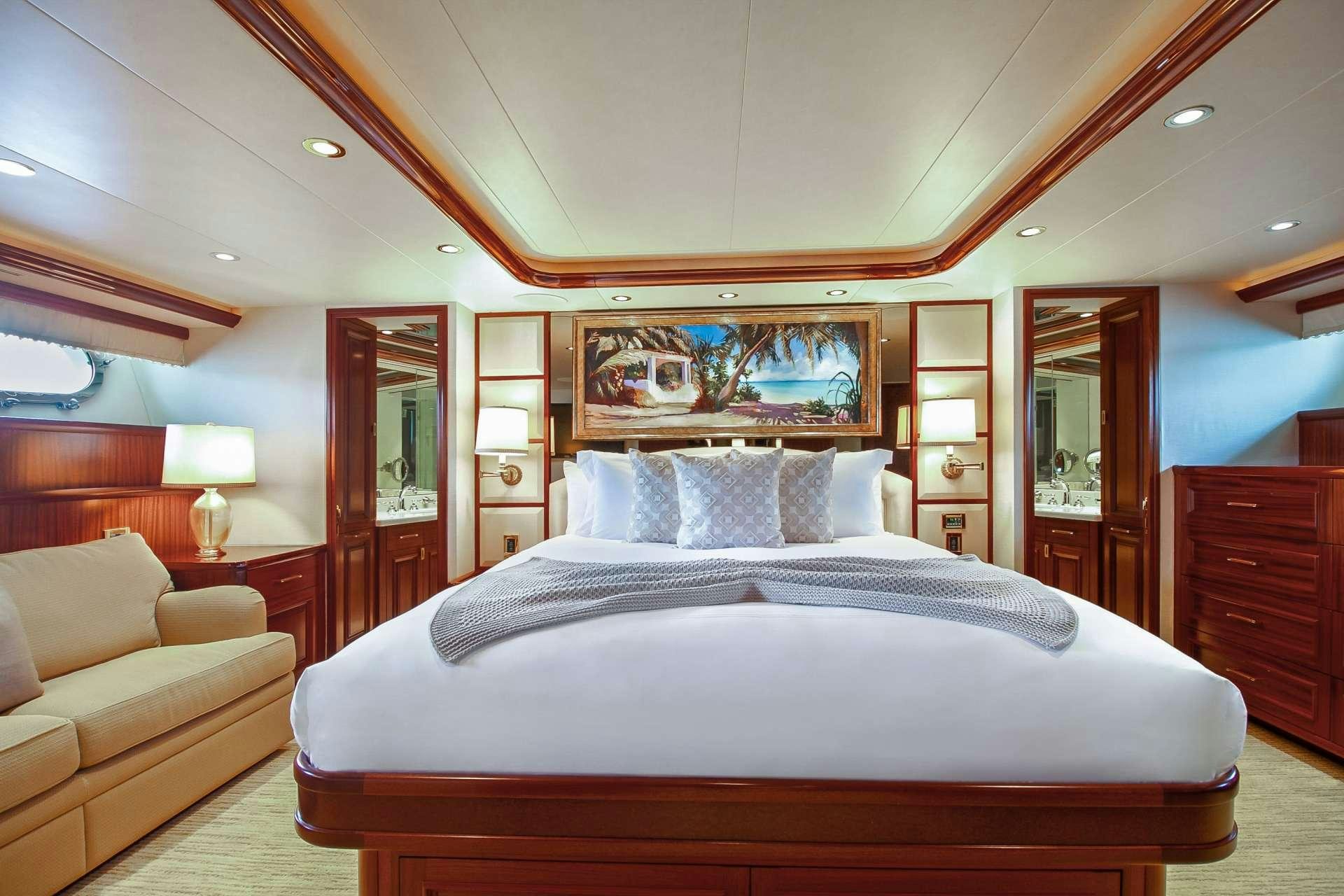 a large bed in a hotel room aboard NAUTI N' Yacht for Charter