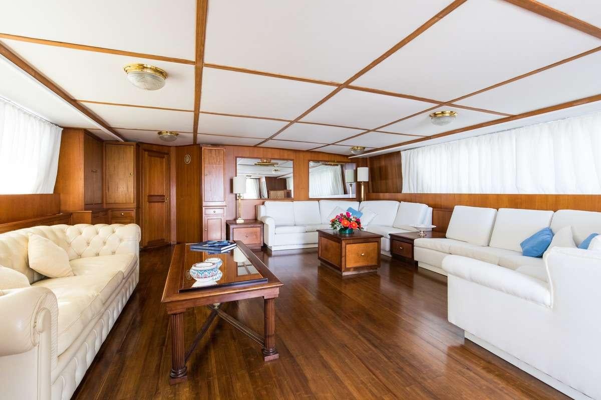a living room with a wood floor aboard Nafisa Yacht for Charter