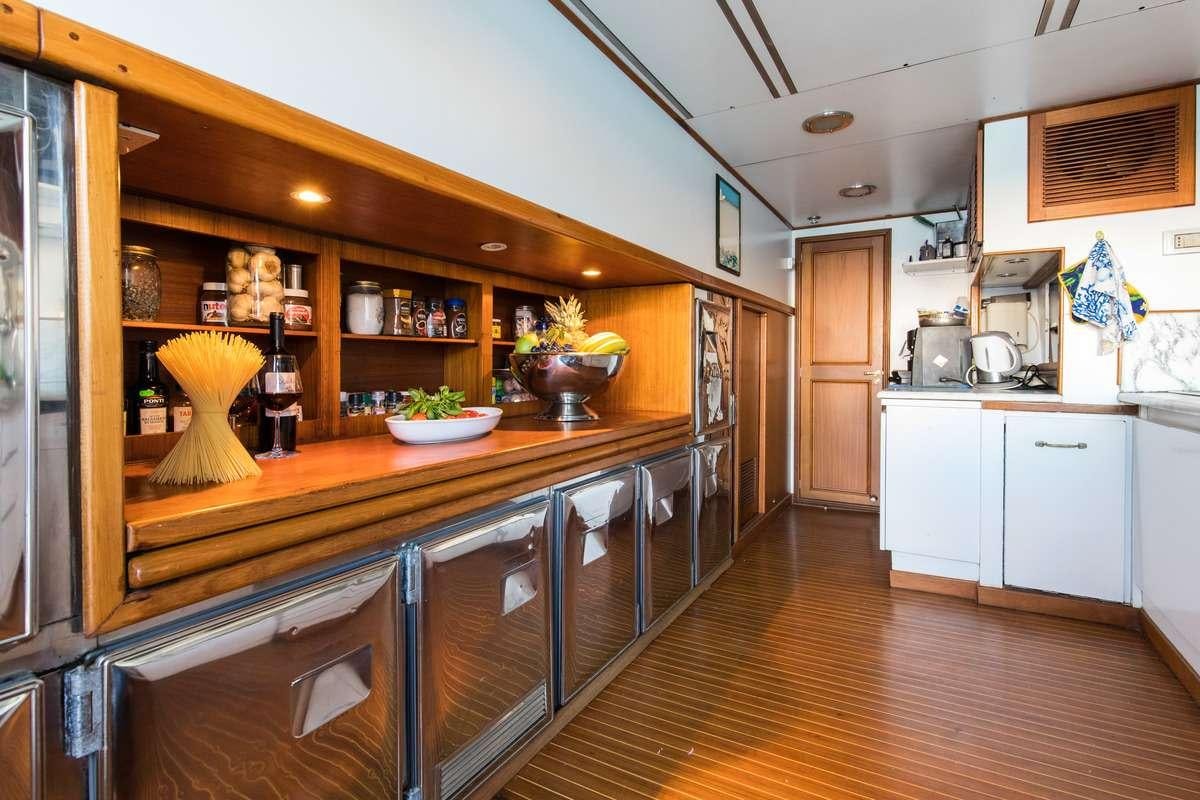 a kitchen with a wood floor aboard Nafisa Yacht for Charter