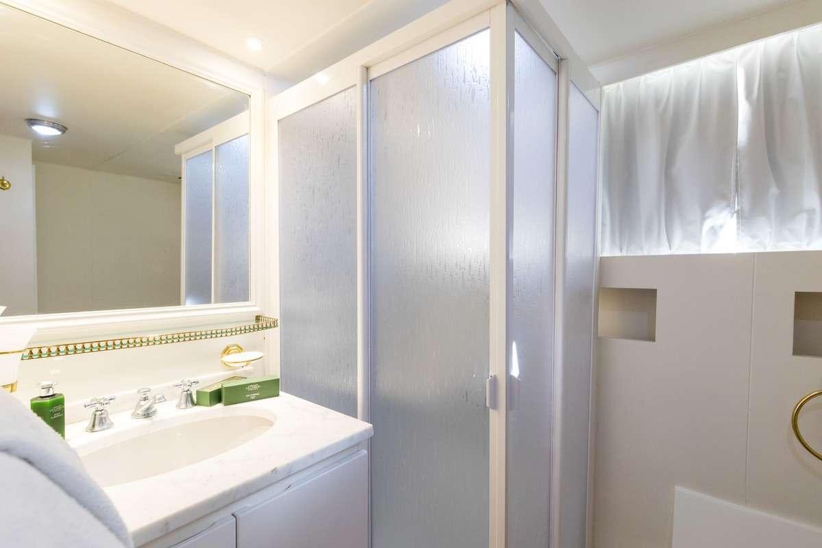 a bathroom with a glass shower aboard Nafisa Yacht for Charter