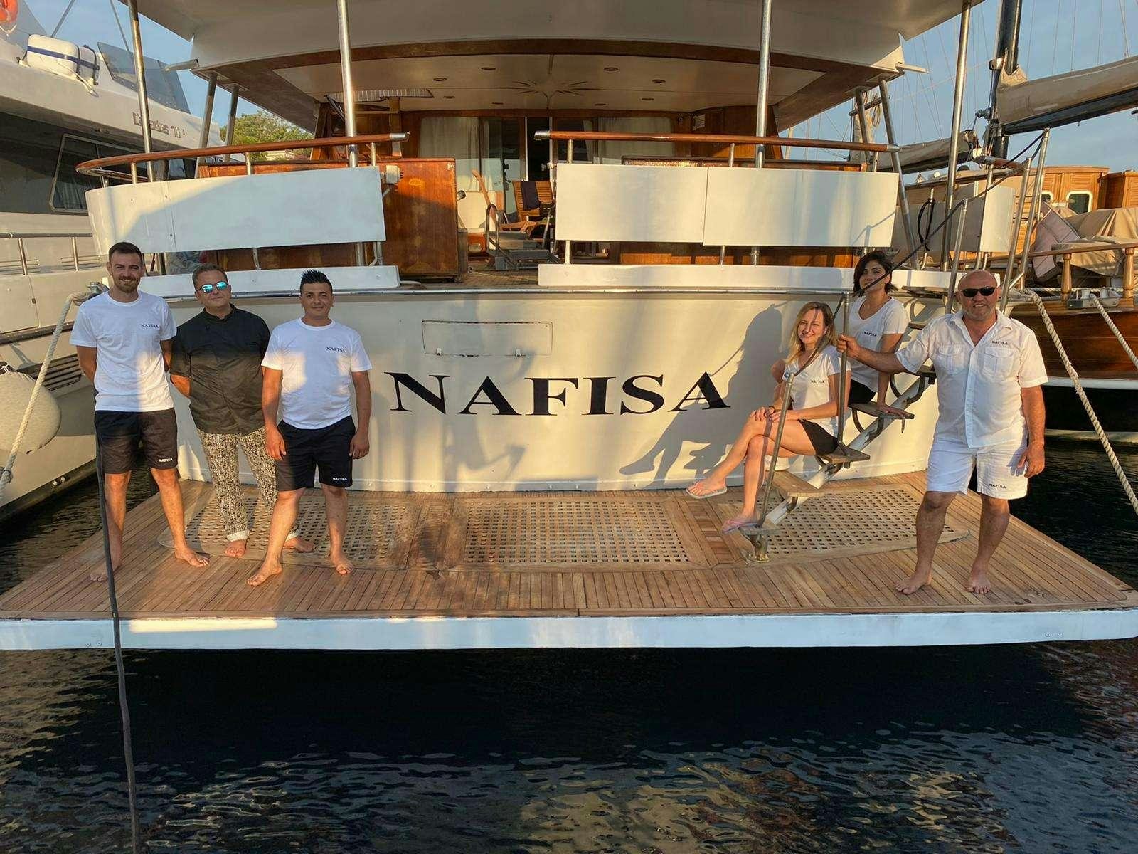 a group of people posing for a photo aboard Nafisa Yacht for Charter