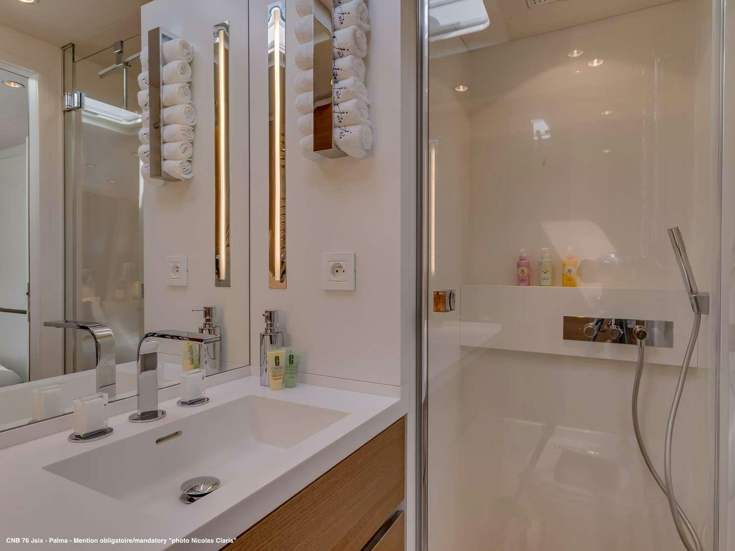 a bathroom with a sink and a mirror aboard J SIX Yacht for Charter