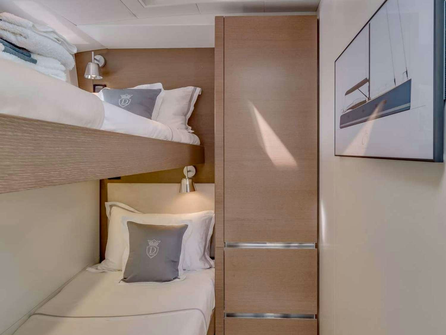 a room with a bed and a closet aboard J SIX Yacht for Charter