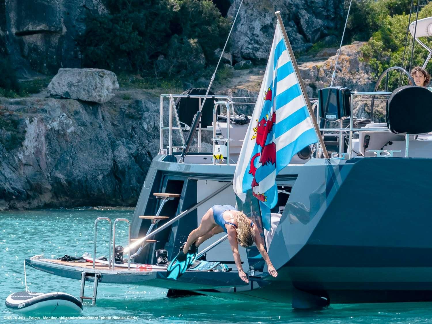 a man on a sailboat aboard J SIX Yacht for Charter
