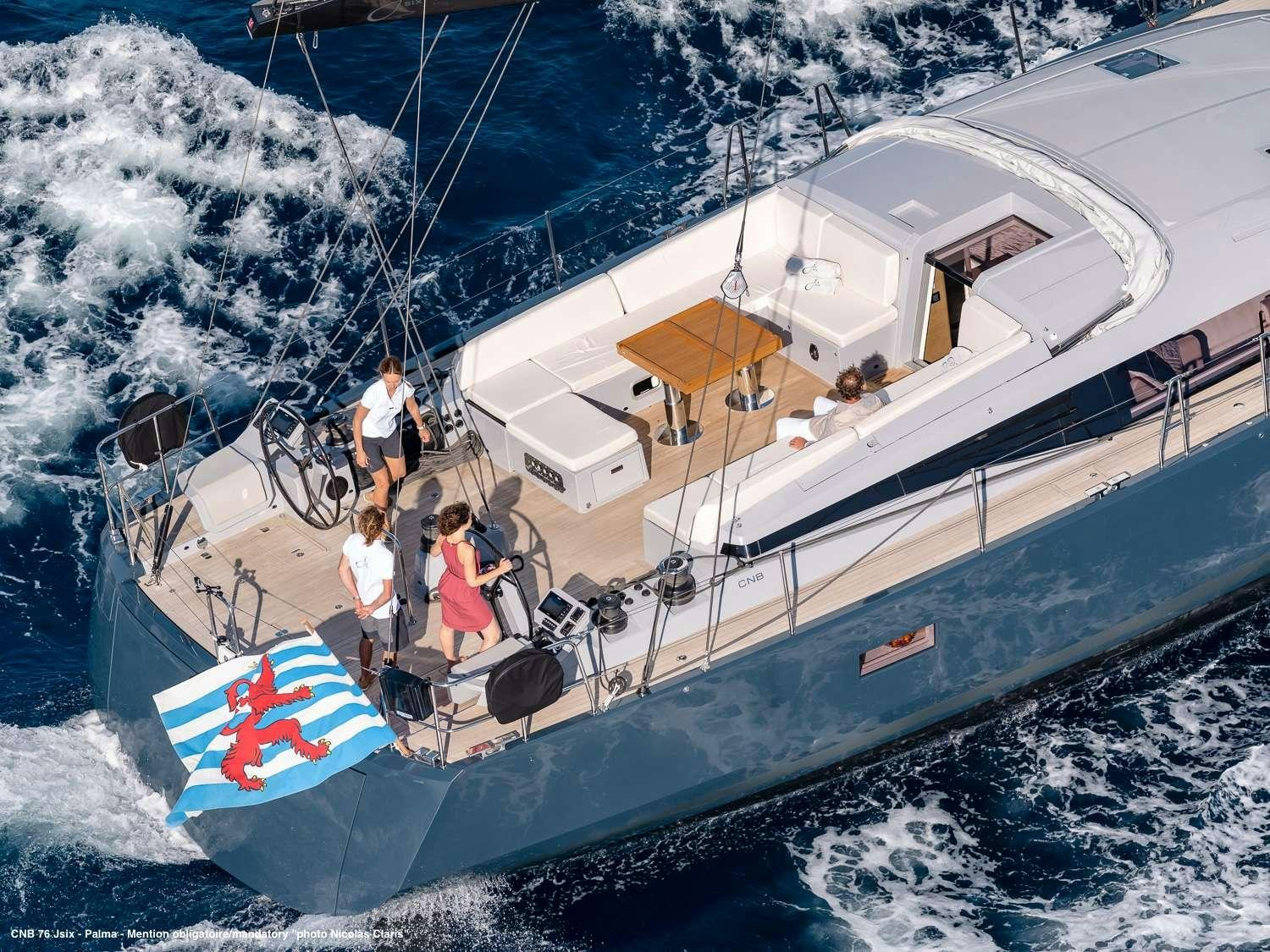 a group of people on a boat aboard J SIX Yacht for Charter