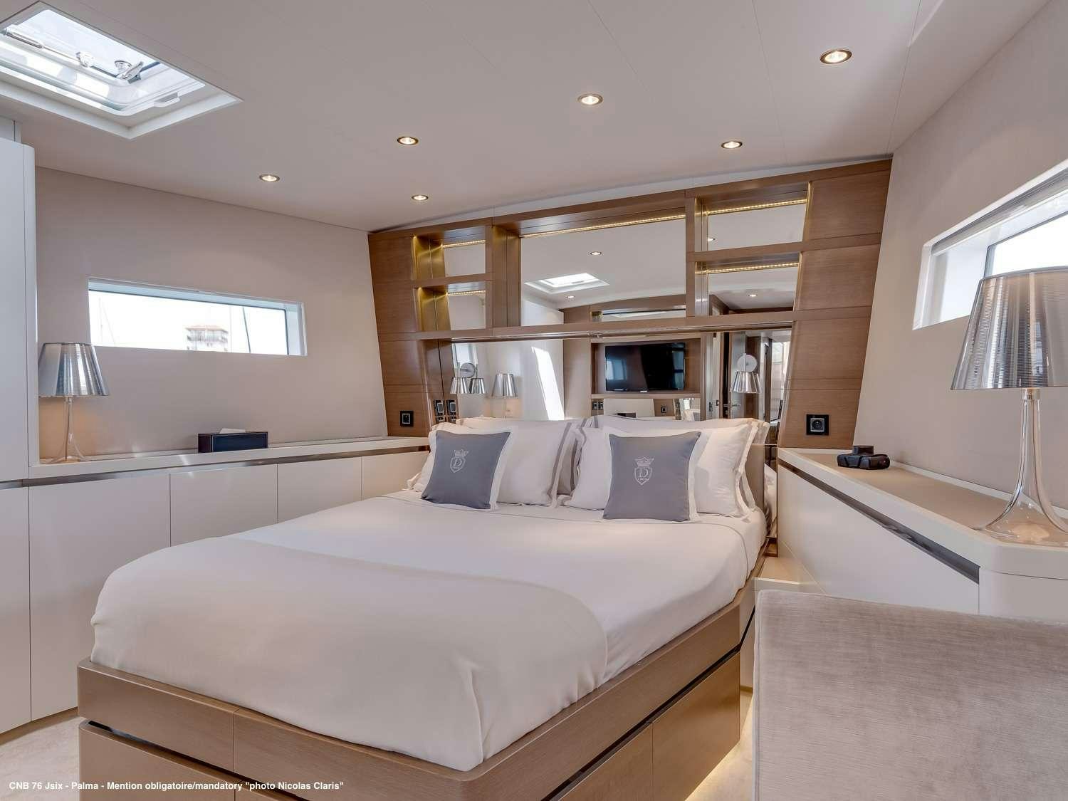 a bedroom with a bed and a desk aboard J SIX Yacht for Charter