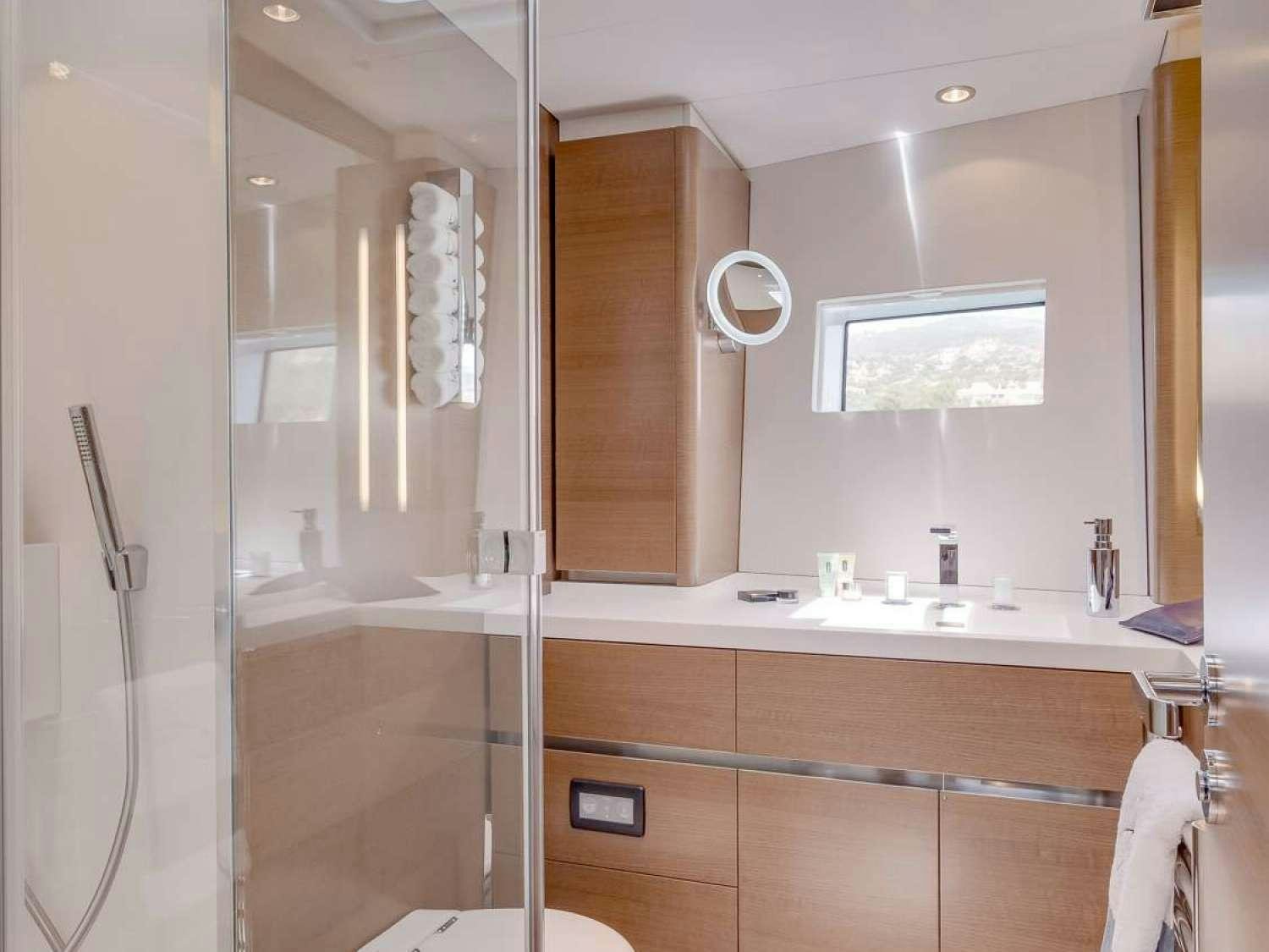 a bathroom with a glass shower aboard J SIX Yacht for Charter
