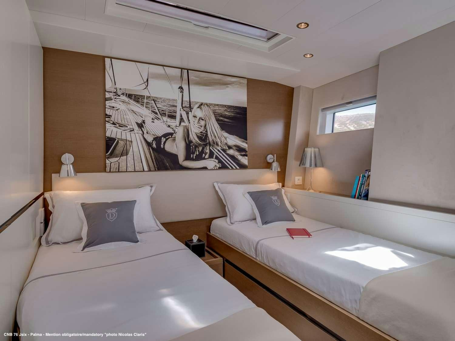 a room with two beds aboard J SIX Yacht for Charter
