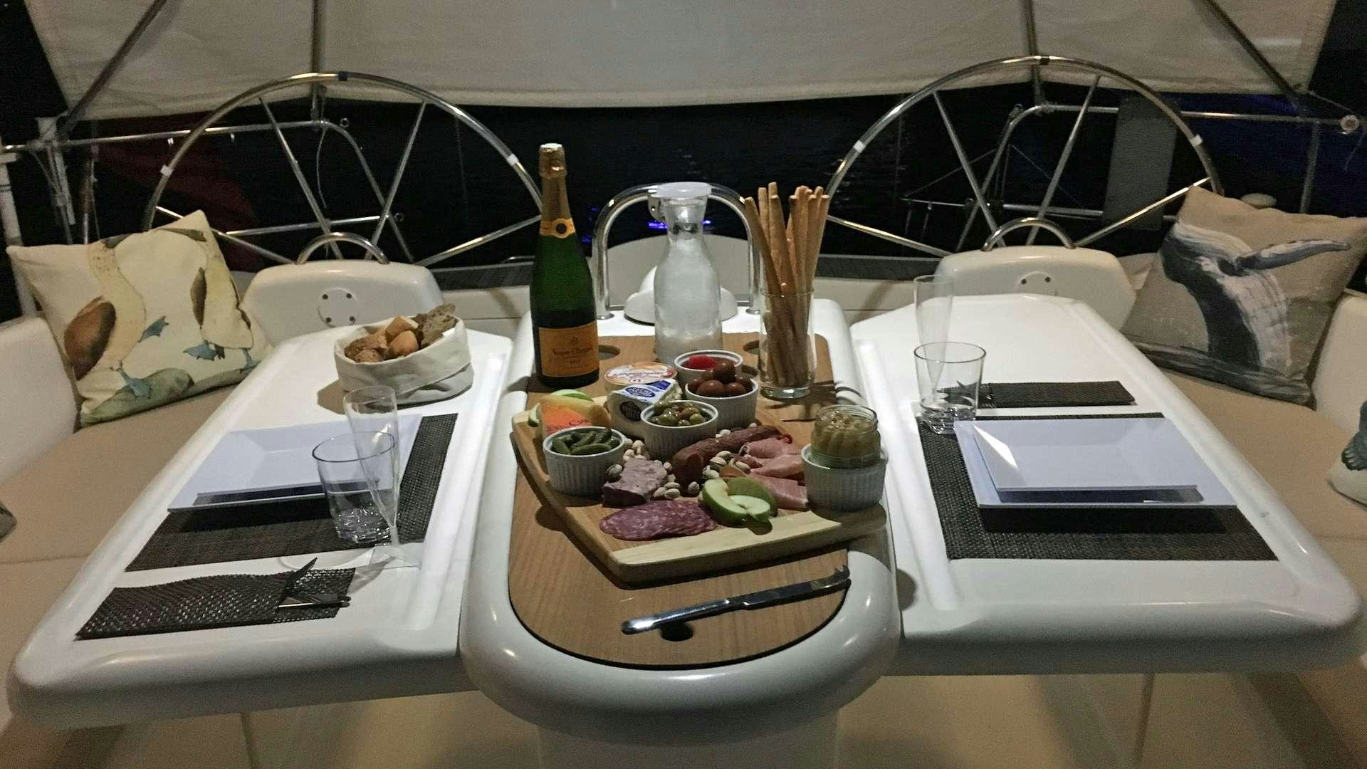 a table with food and drinks aboard NEMO SY Yacht for Charter