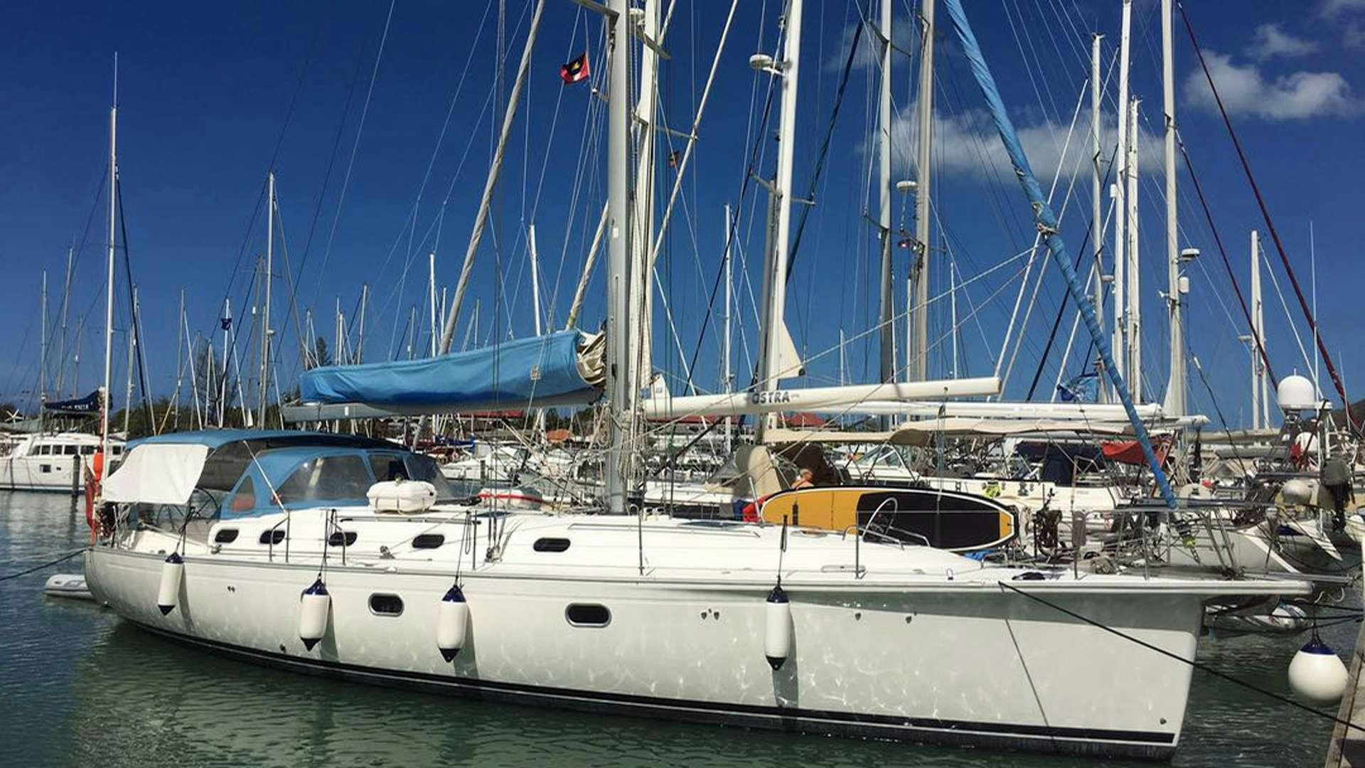 a white boat in a harbor aboard NEMO SY Yacht for Charter