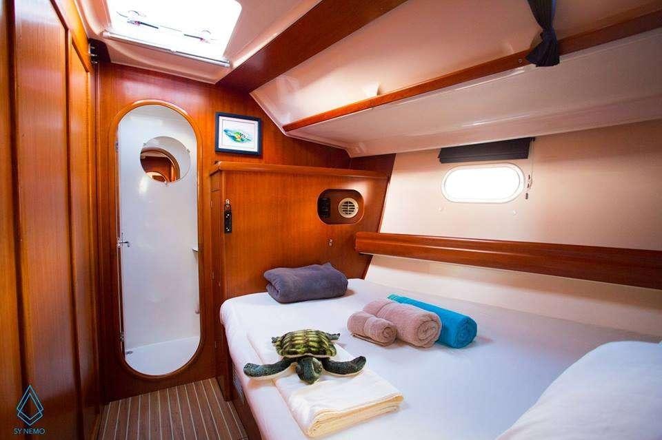 a bed in a room aboard NEMO SY Yacht for Charter